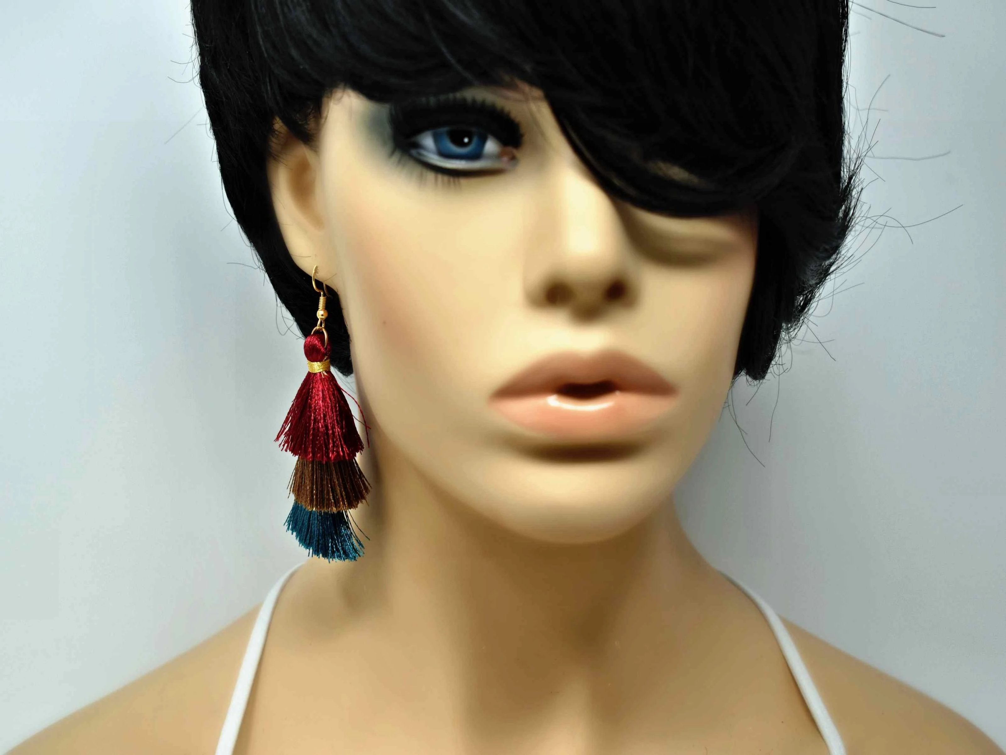 You can count on our Allium earrings to provide you with a little fringe with benefits.  These triple layered burgundy, brown and green fringe earrings are a beautiful addition with there fish hook clasp. They measure 3 1/2" in length.