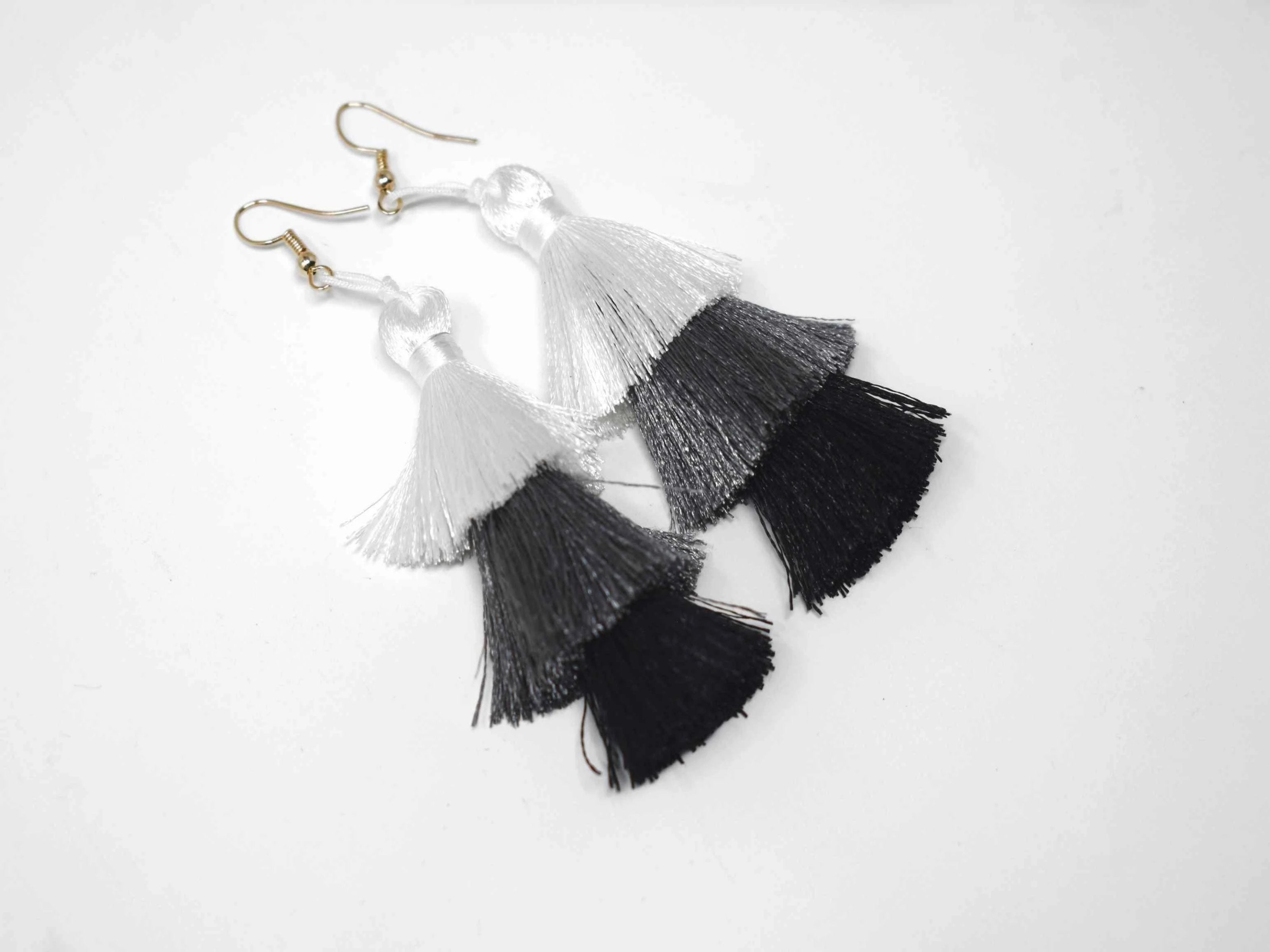 You can count on our Allium earrings to provide you with a little fringe with benefits.  These triple layered white grey and black earrings are a beautiful addition with there fish hook clasp. They measure 3 1/2" in length.