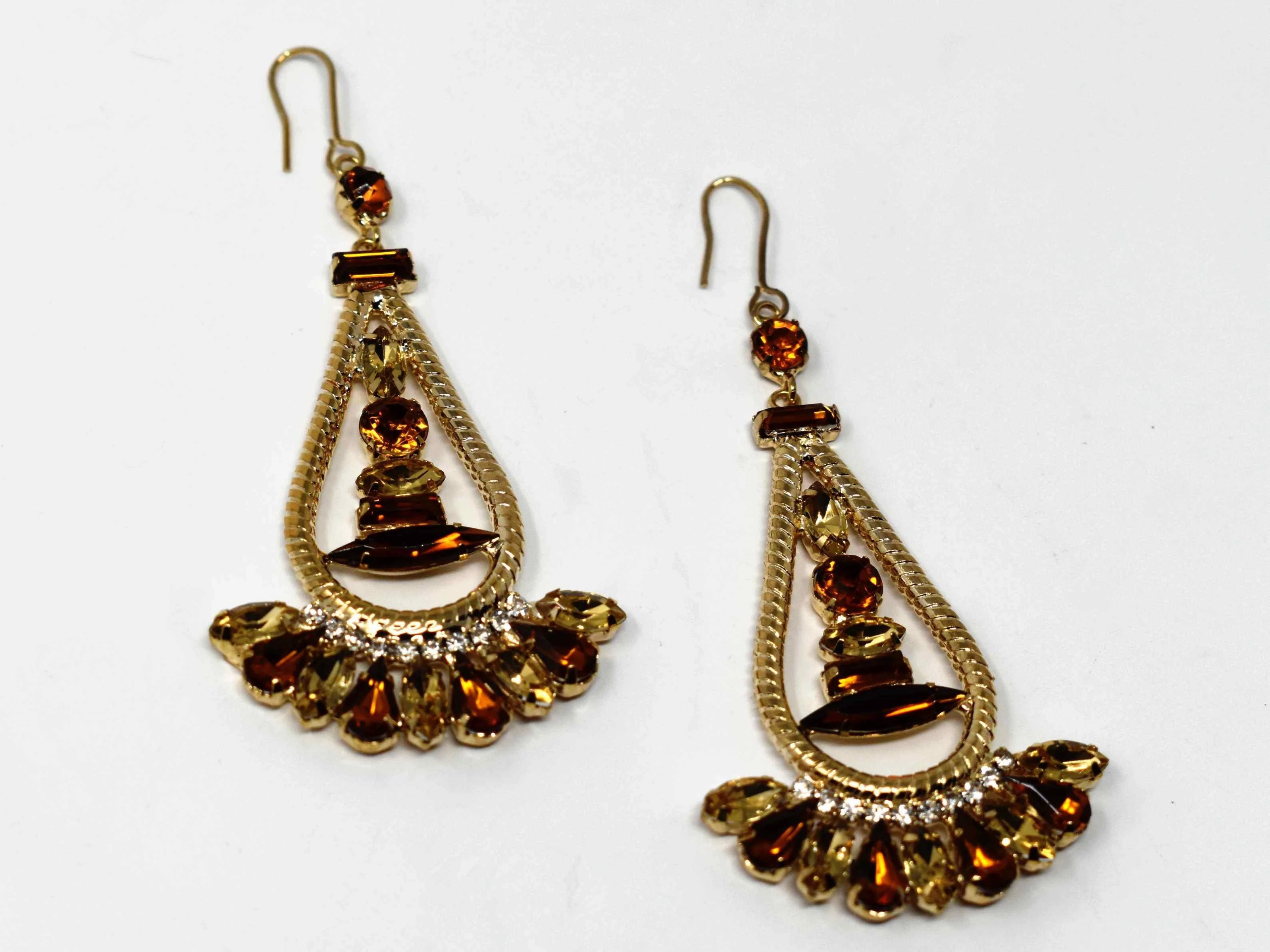 Anemone is a gold with bronze stone eye catching drop , dangle style earring. It comes with a fish hook clasp and is 3 inches in length.