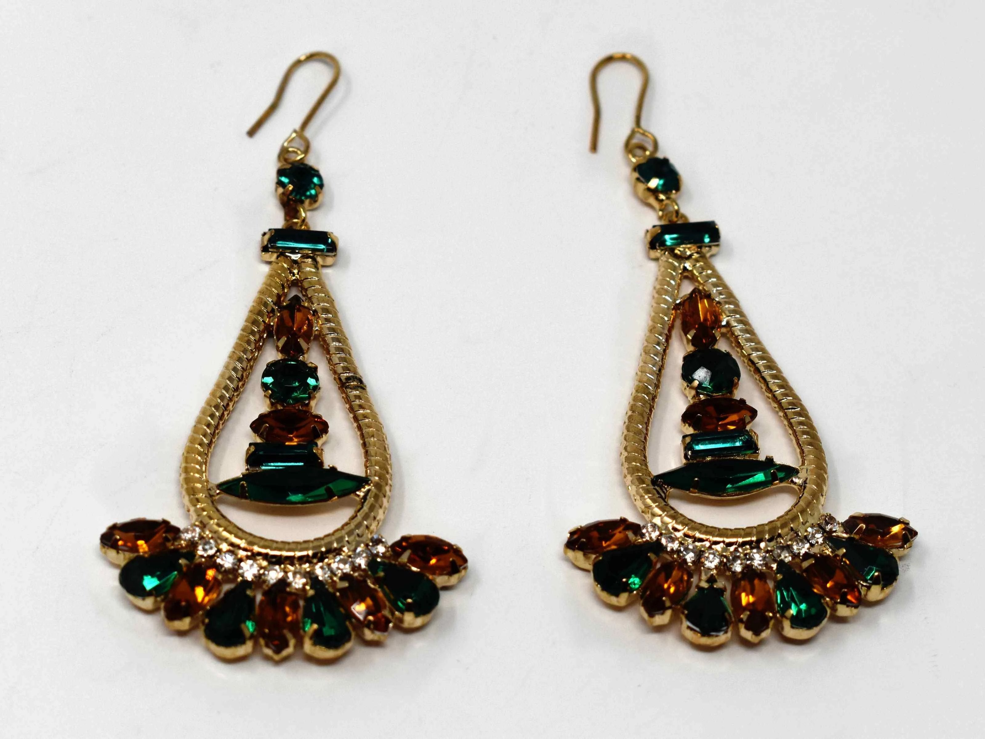 Anemone is a gold with a bronze and green stone eye catching drop , dangle style earring. It comes with a fish hook clasp and is 3 inches in length.