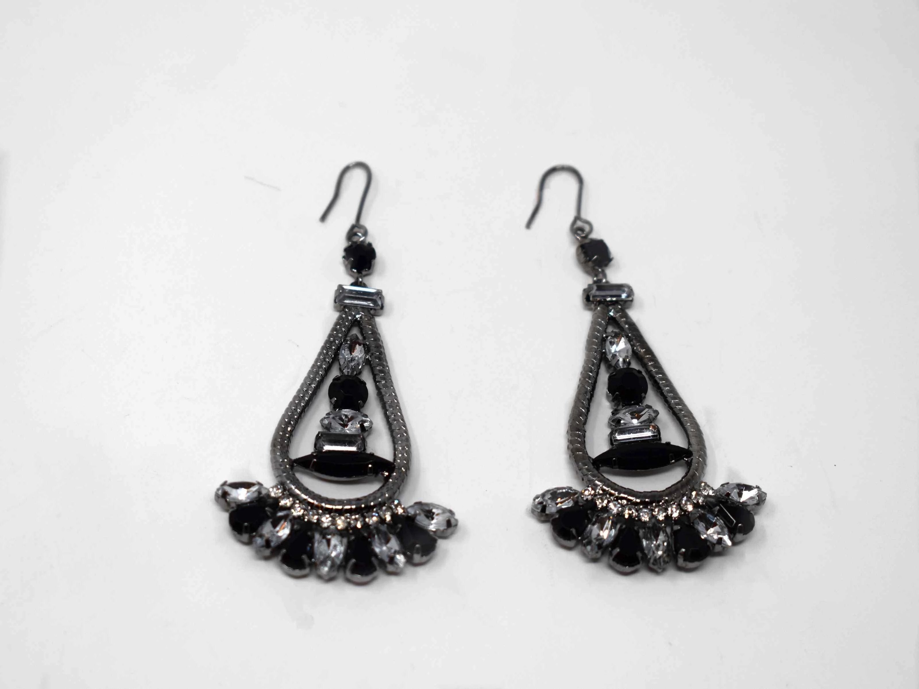 Anemone is a silver with clear  and black stone eye catching drop , dangle style earring. It comes with a fish hook clasp and is 3 inches in length.