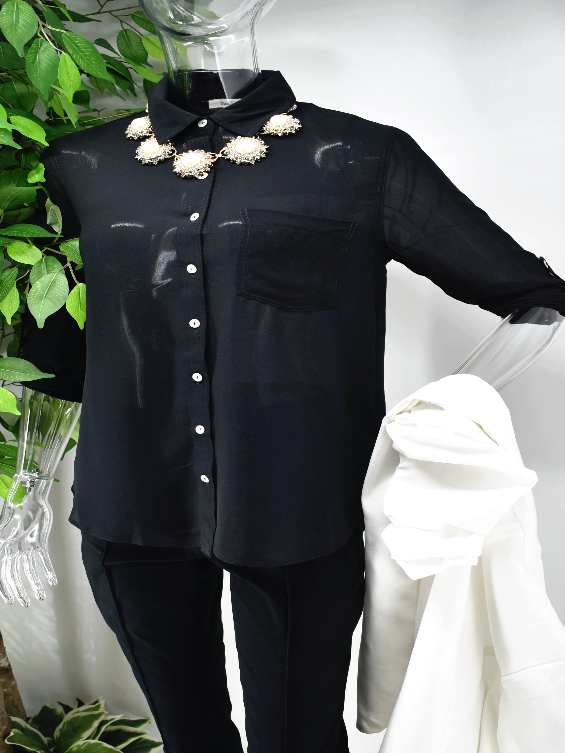 Enjoy an elegant design that never fades with our classic Bayla shirt blouse. Our Bayla is a black button front shirt blouse loose in fit with a classic rolled cuffed sleeve. 