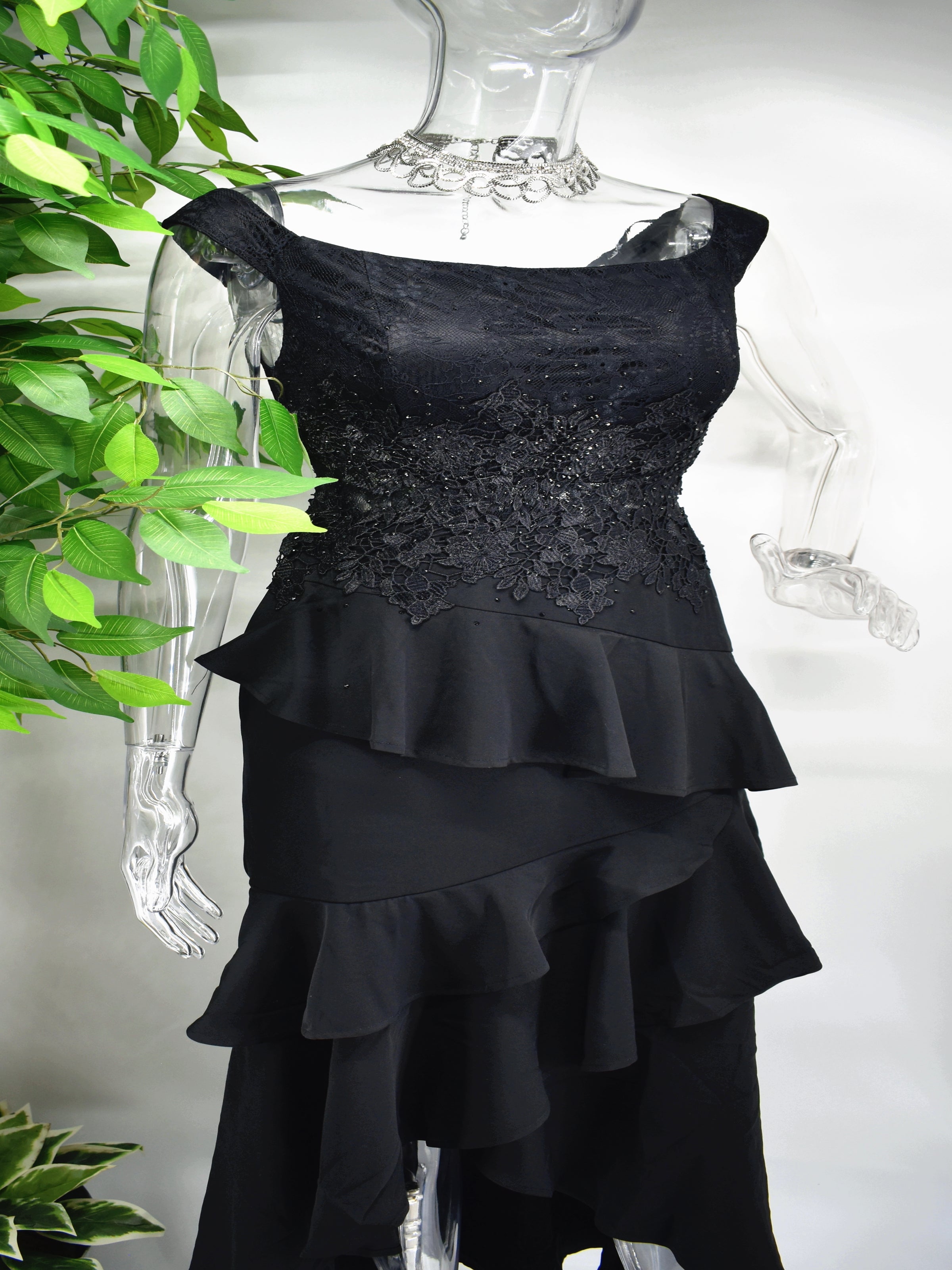 There is so much to love about our incredible Bedelia Black dress. The black formal dress has a boat neckline accompanied by a beaded bodice and frills cascading down to the hem of the dress.  