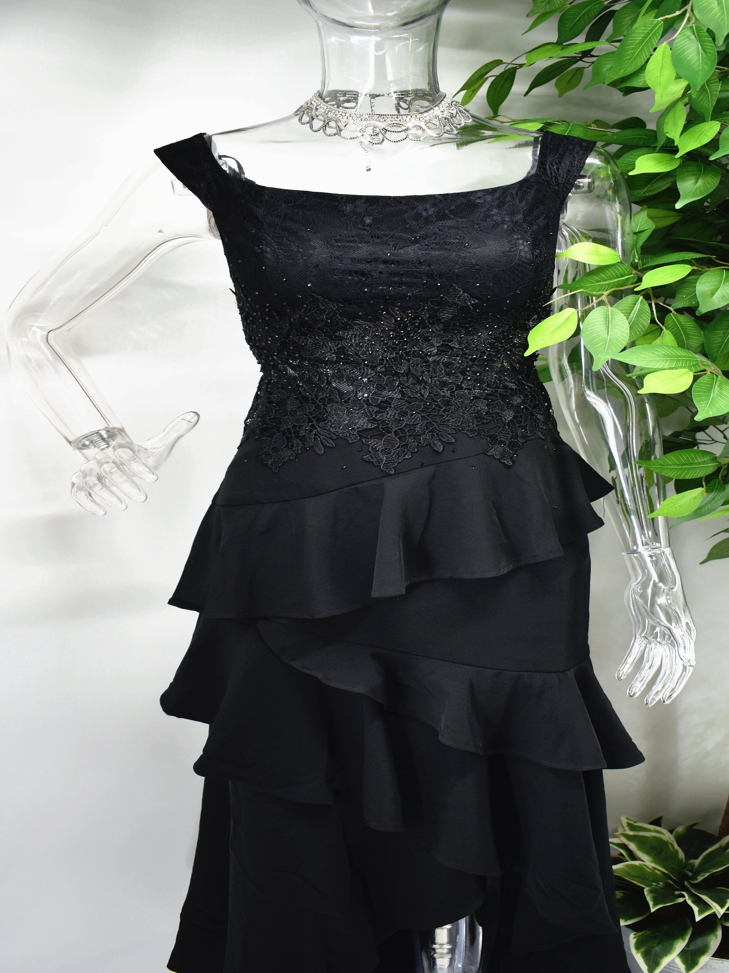 There is so much to love about our incredible Bedelia Black dress. The black formal dress has a boat neckline accompanied by a beaded bodice and frills cascading down to the hem of the dress.  