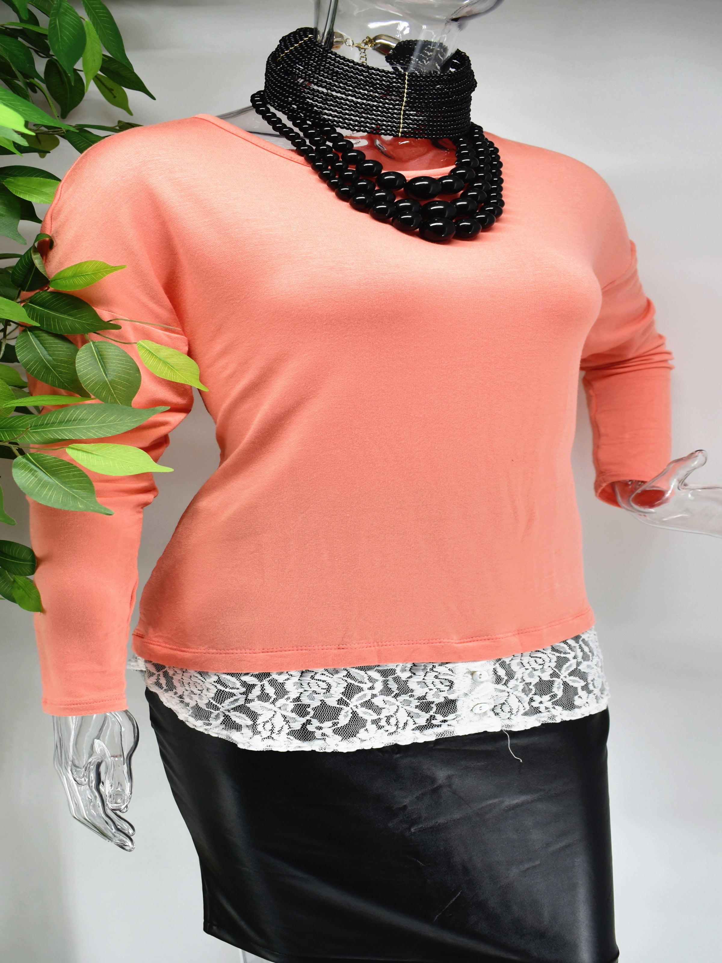 Influence the outcome today in our Belina top. Our Belina is a soft knit peach colored top with lace at the base of the of the top. 