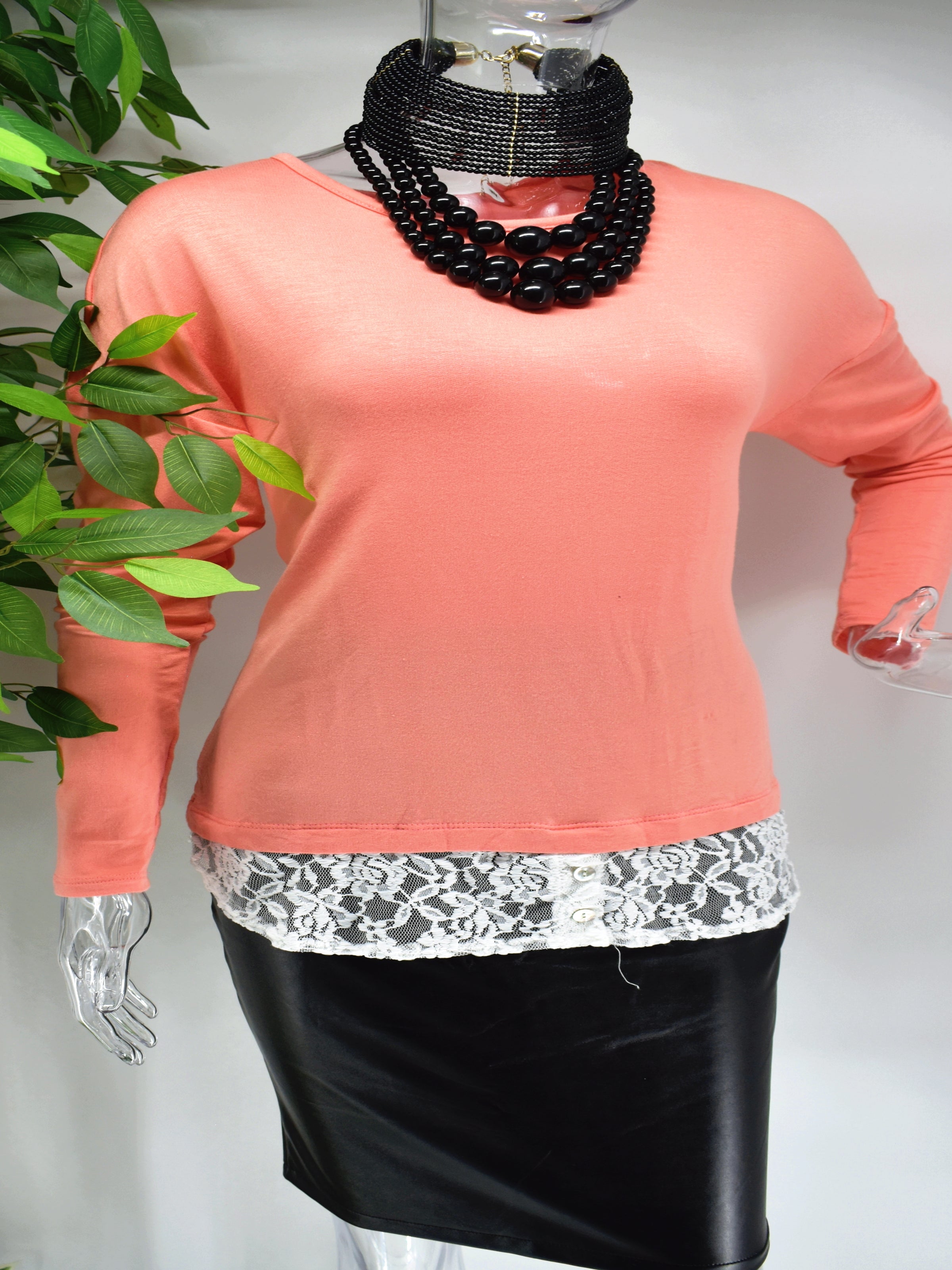 Influence the outcome today in our Belina top. Our Belina is a soft knit peach colored top with lace at the base of the of the top. 