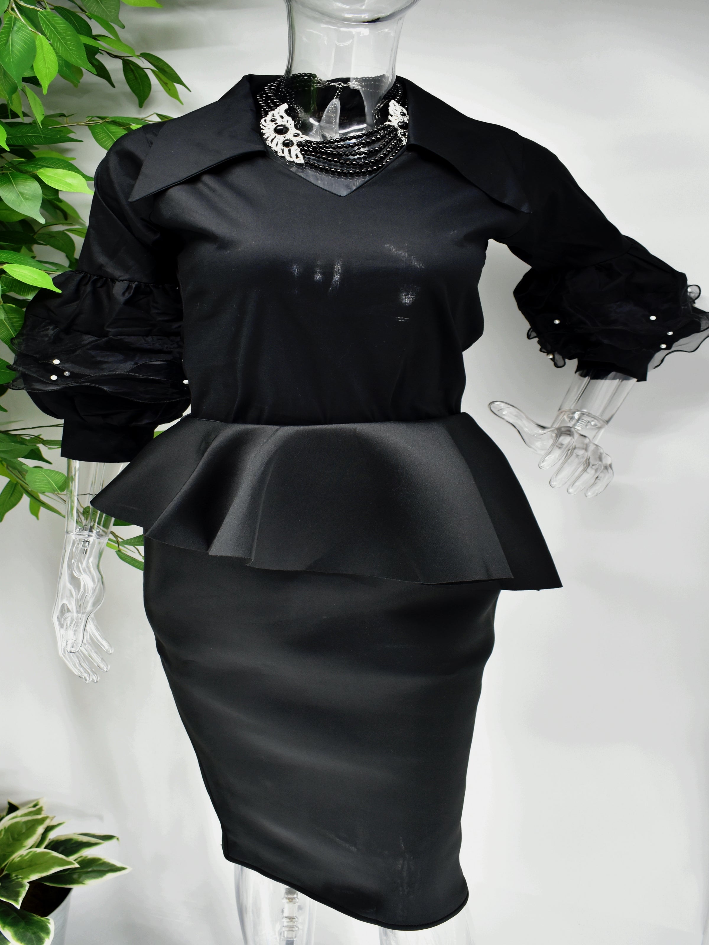 You can never do wrong in our Belita Shirt top.  Our Belita shirt top is black with an edgy collar and v neckline.  The beauty is in those sleeves which run into a ballon sleeve piped with lace and accented with pearls.