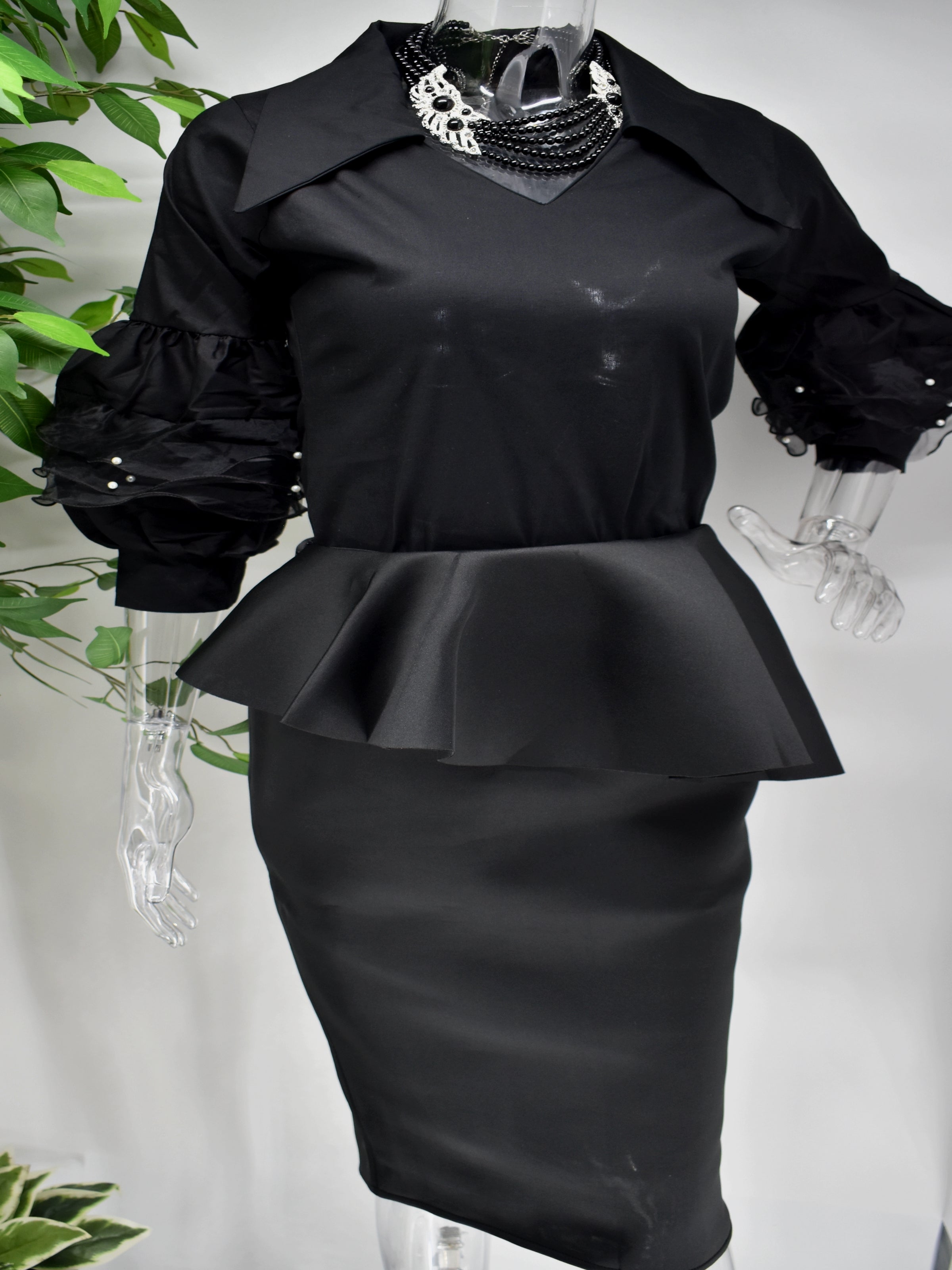 You can never do wrong in our Belita Shirt top.  Our Belita shirt top is black with an edgy collar and v neckline.  The beauty is in those sleeves which run into a ballon sleeve piped with lace and accented with pearls.