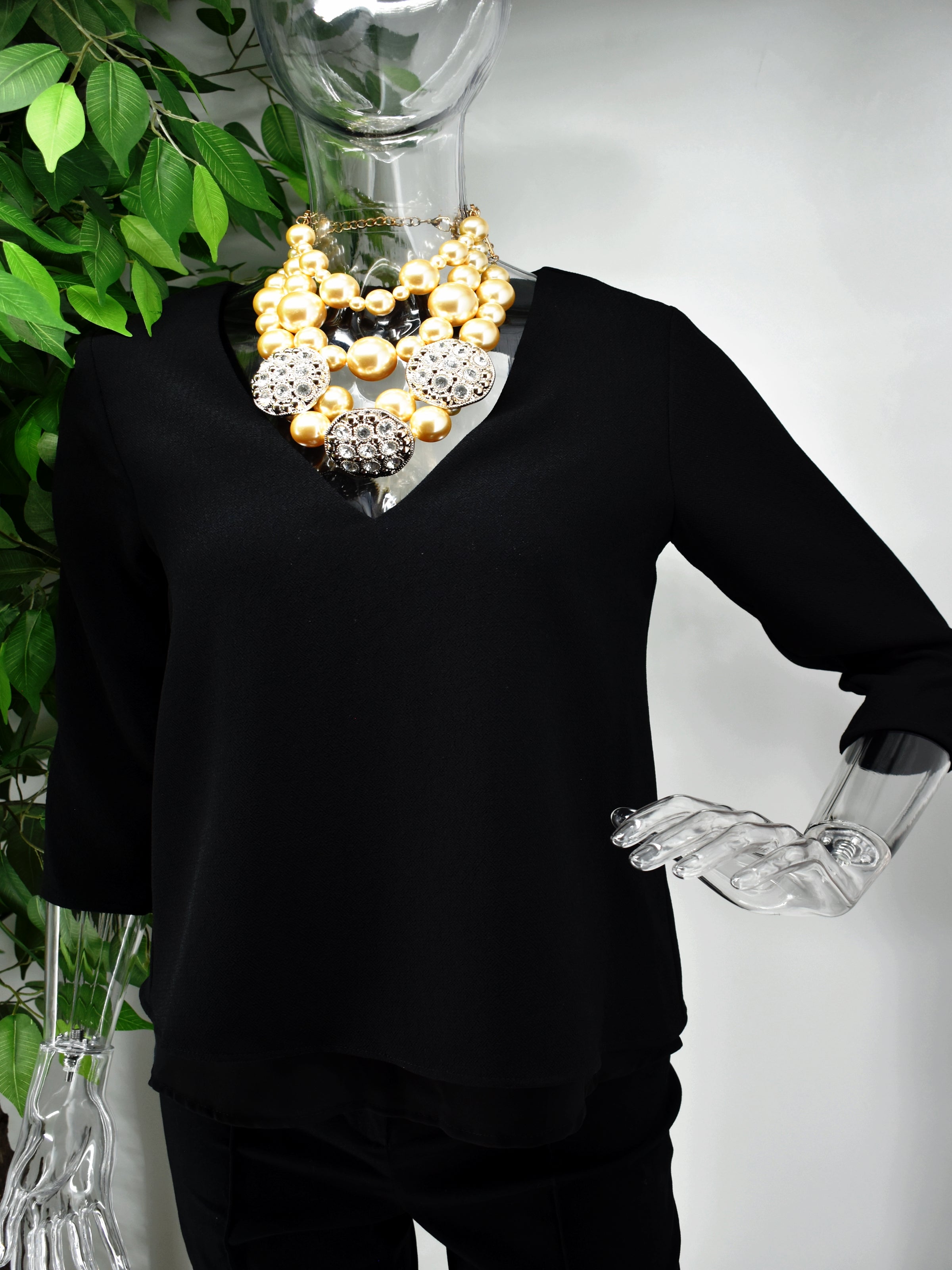 You can do no wrong in our Bernessa Blouse. Bernessa is a black v neck blouse with an accent gold zip to the back of the blouse. 