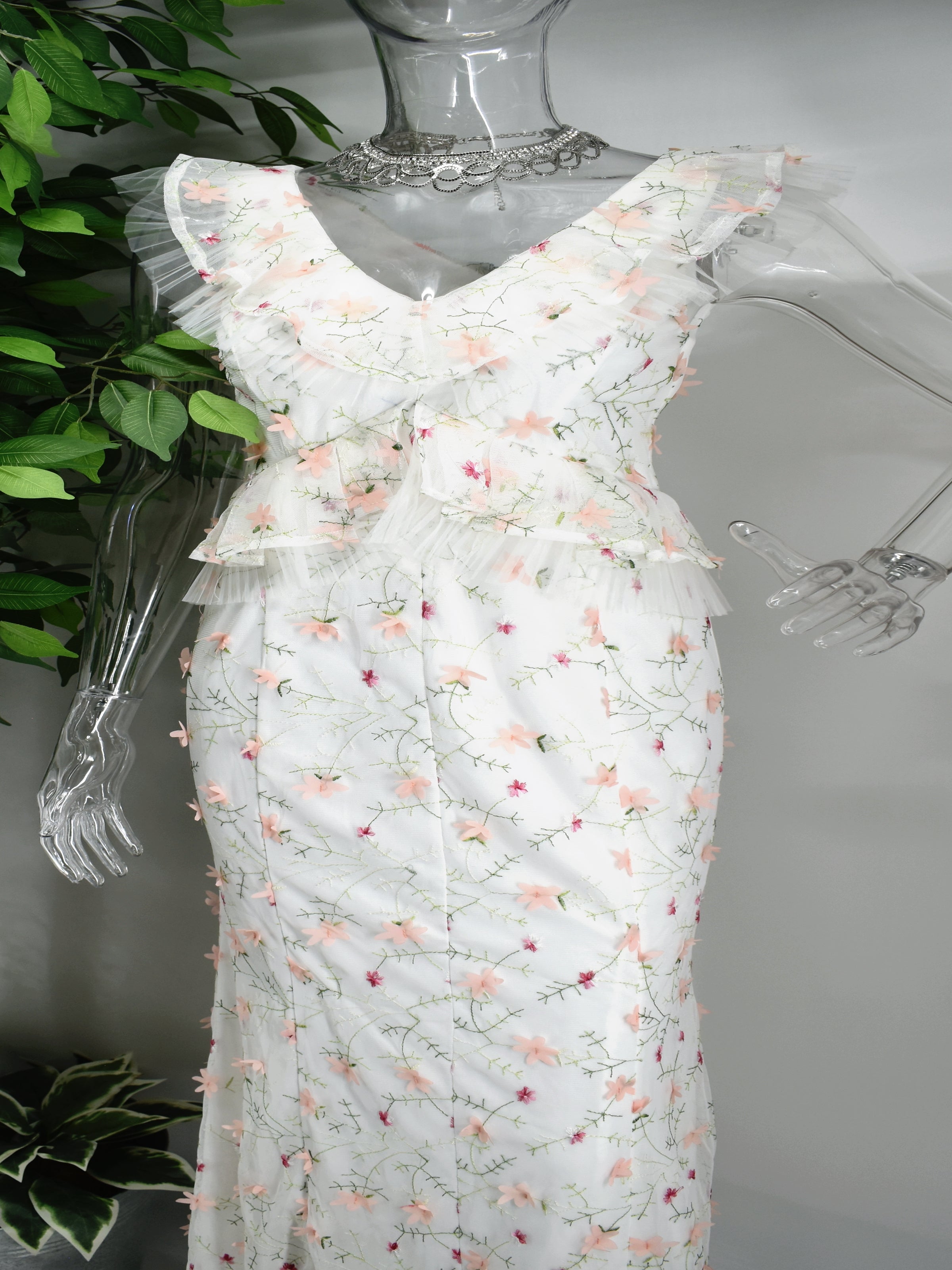 There will be no competing with our Beula long floral dress. Buela is a long  white maxi dress with accented with a floral design. Unique on its own Beula has a ruffled V- neckline cinched bodice also accented with ruffles. 