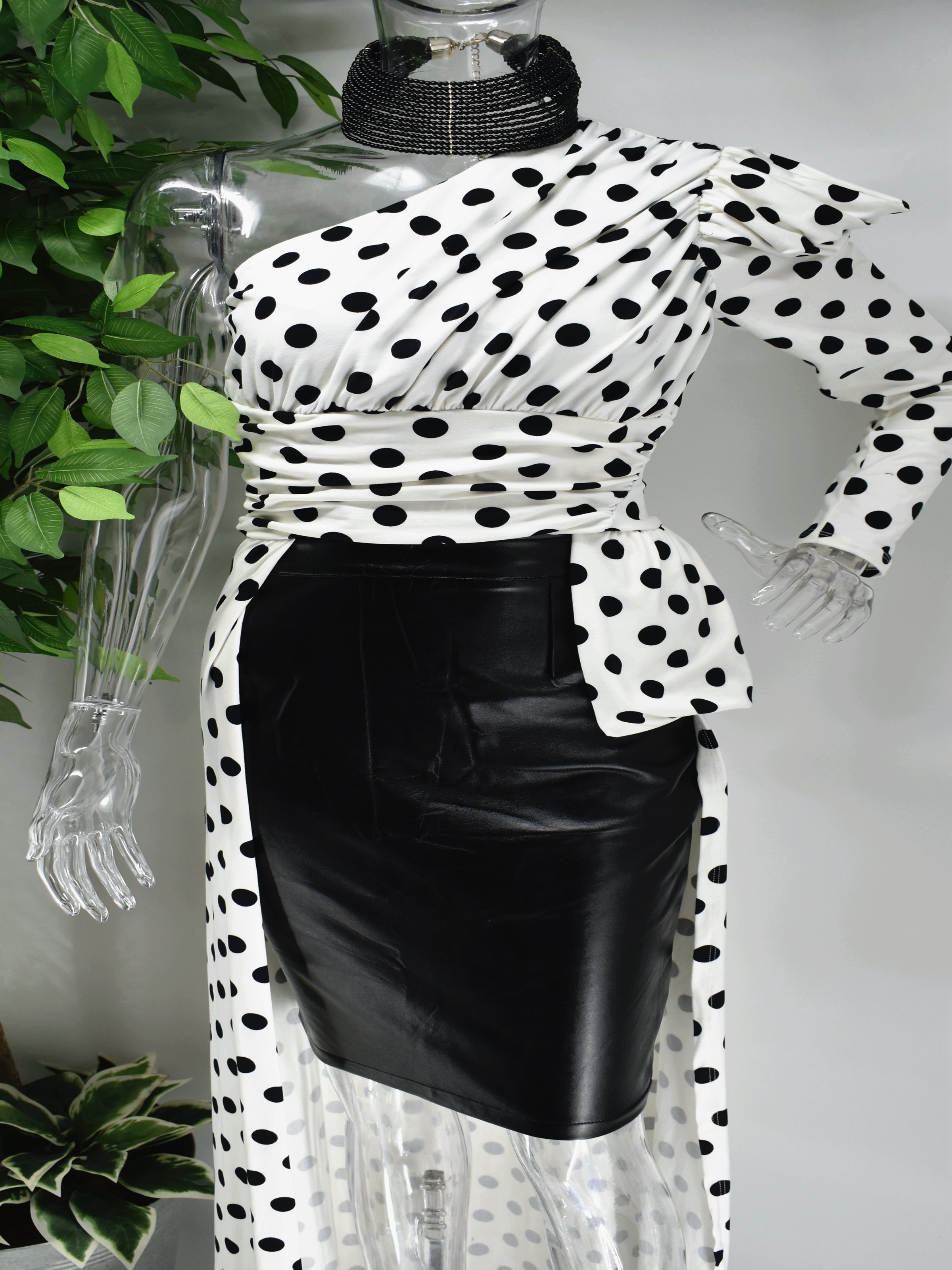 Let's go out and get Jiggy in our Biddy white with black polka dot top. Biddy's unique one sleeved asymmetrical design is complimented with a short and long hem. This top would be great paired with skirts, pants leggings or shorts.
