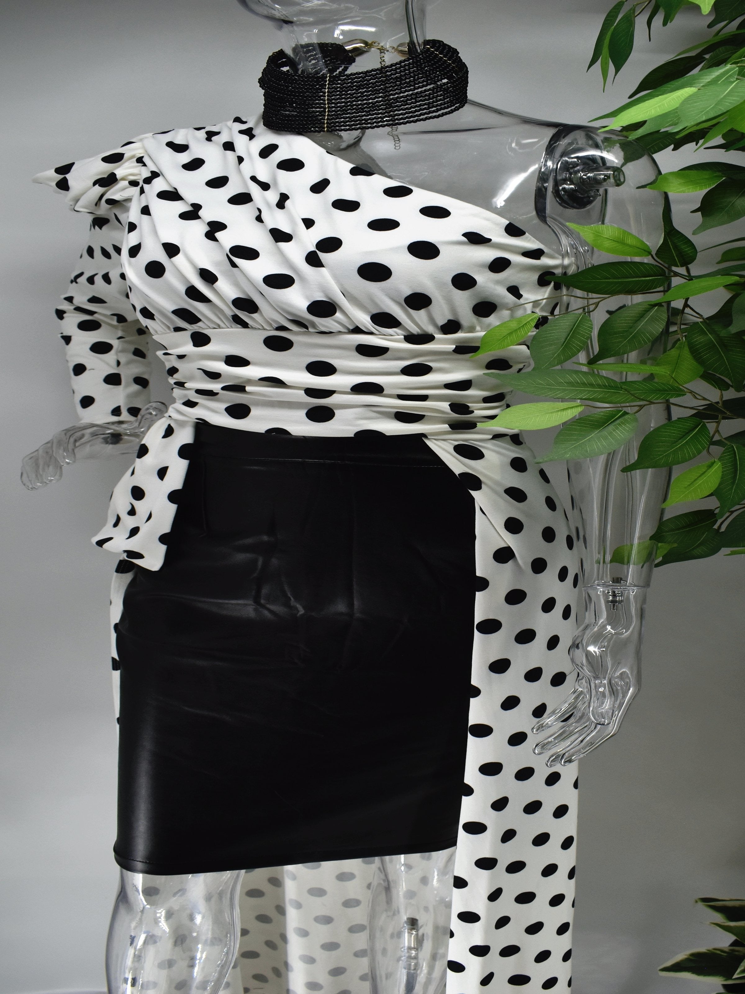 Let's go out and get Jiggy in our Biddy white with black polka dot top. Biddy's unique one sleeved asymmetrical design is complimented with a short and long hem. This top would be great paired with skirts, pants leggings or shorts.