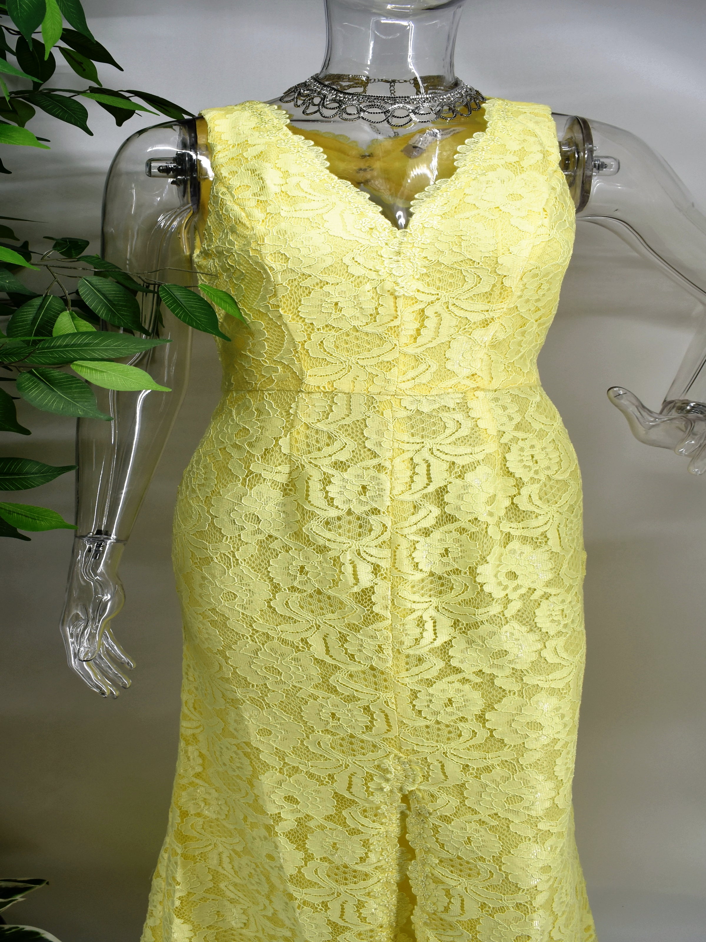 Always be on the minds of others in our Bonnell lace dress. Our Bonnell is a V-neck sleeveless yellow long dress adorned with lace and accented with a center slit that rises a little above the knee.