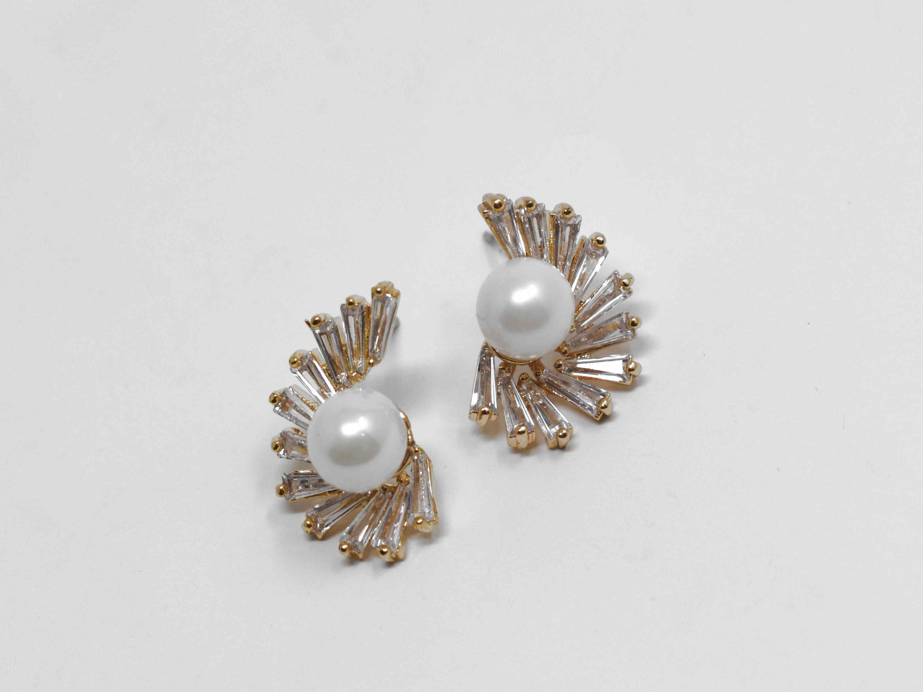 Our bouvardia earrings are a beautiful classic with a modern twist. These knob earrings have a pearl core adorned with cascading stones. They are 3/4 of an inch in length with a push back clasp.