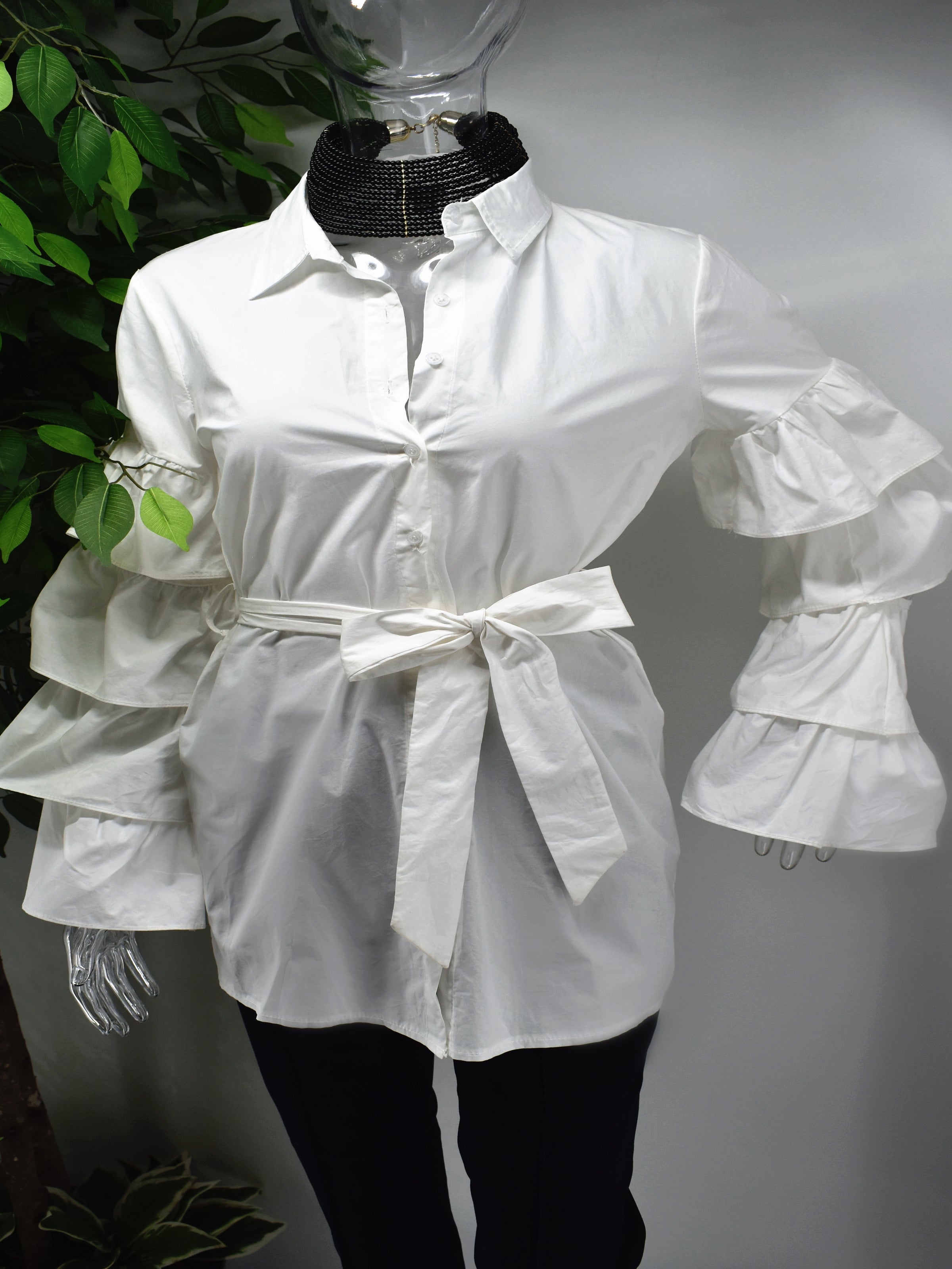 Turn heads and represent how fashionably fierce you are in our Brandis White ruffle sleeve shirt top.  Our Brandis is a long button front shirt top with a traditional collar and a romantic bold four tiered ruffle sleeve.