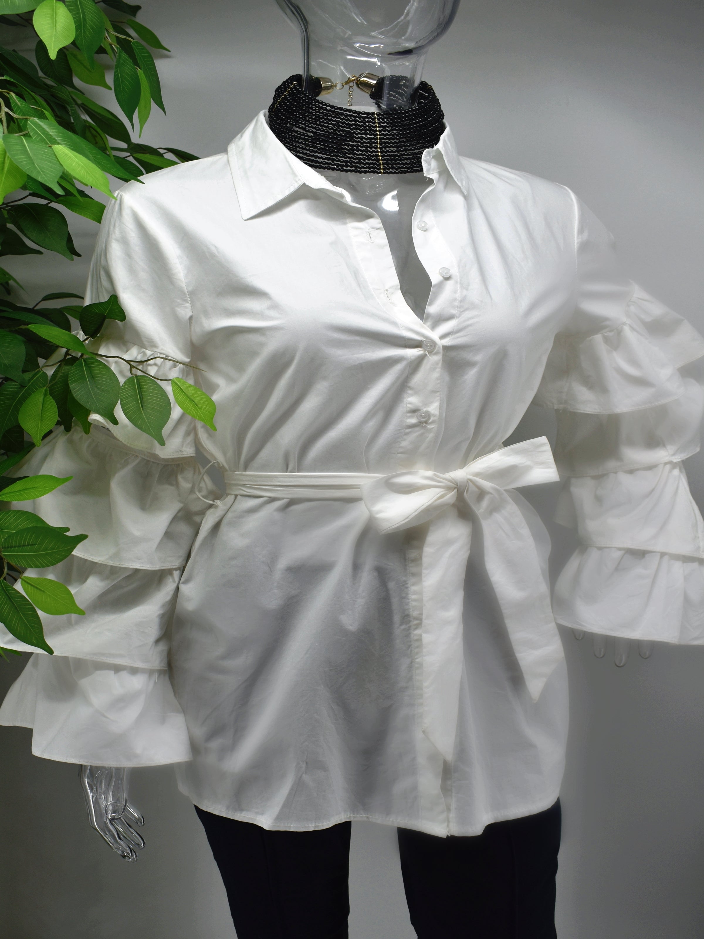Turn heads and represent how fashionably fierce you are in our Brandis White ruffle sleeve shirt top.  Our Brandis is a long button front shirt top with a traditional collar and a romantic bold four tiered ruffle sleeve.