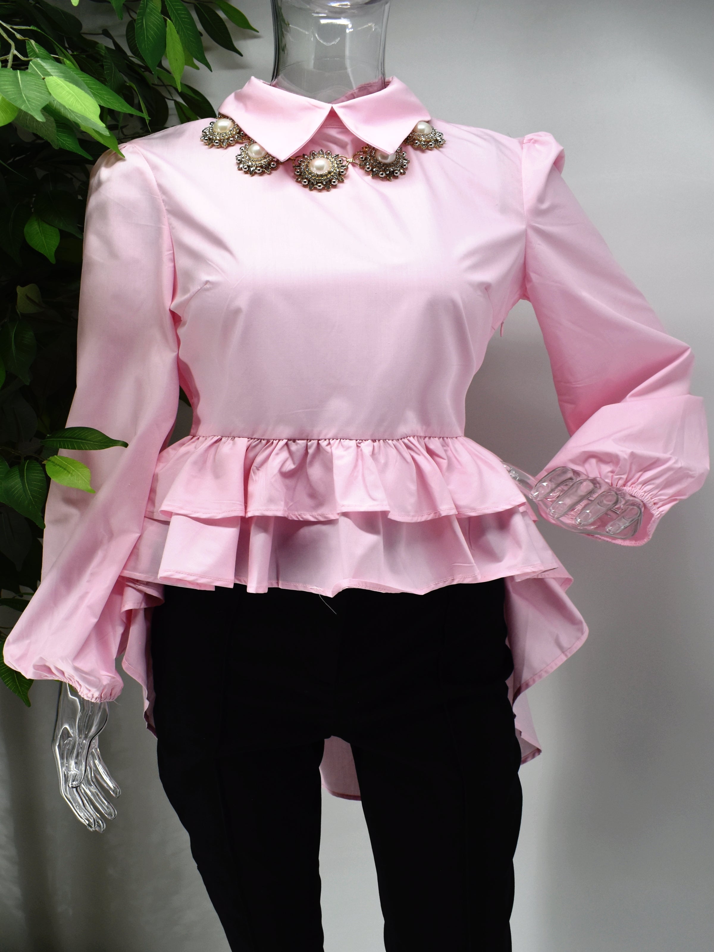 Fashion forward yet comfortably chic is what our Brier pink shirt Blouse will deliver.  Brier is a pink shirt blouse with a ruffled peplum waistline with the back hem longer than the front. 