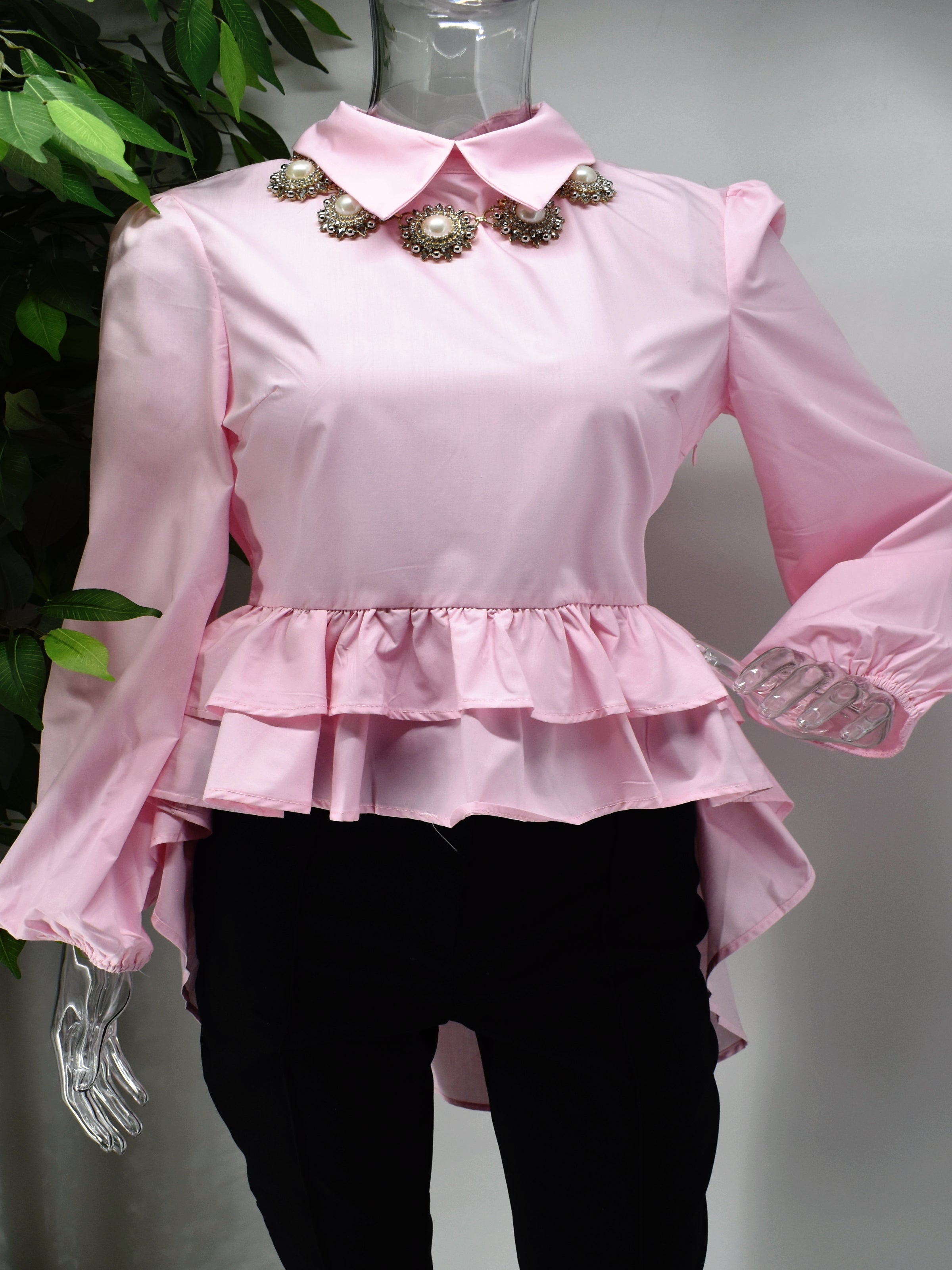 Fashion forward yet comfortably chic is what our Brier pink shirt Blouse will deliver.  Brier is a pink shirt blouse with a ruffled peplum waistline with the back hem longer than the front. 