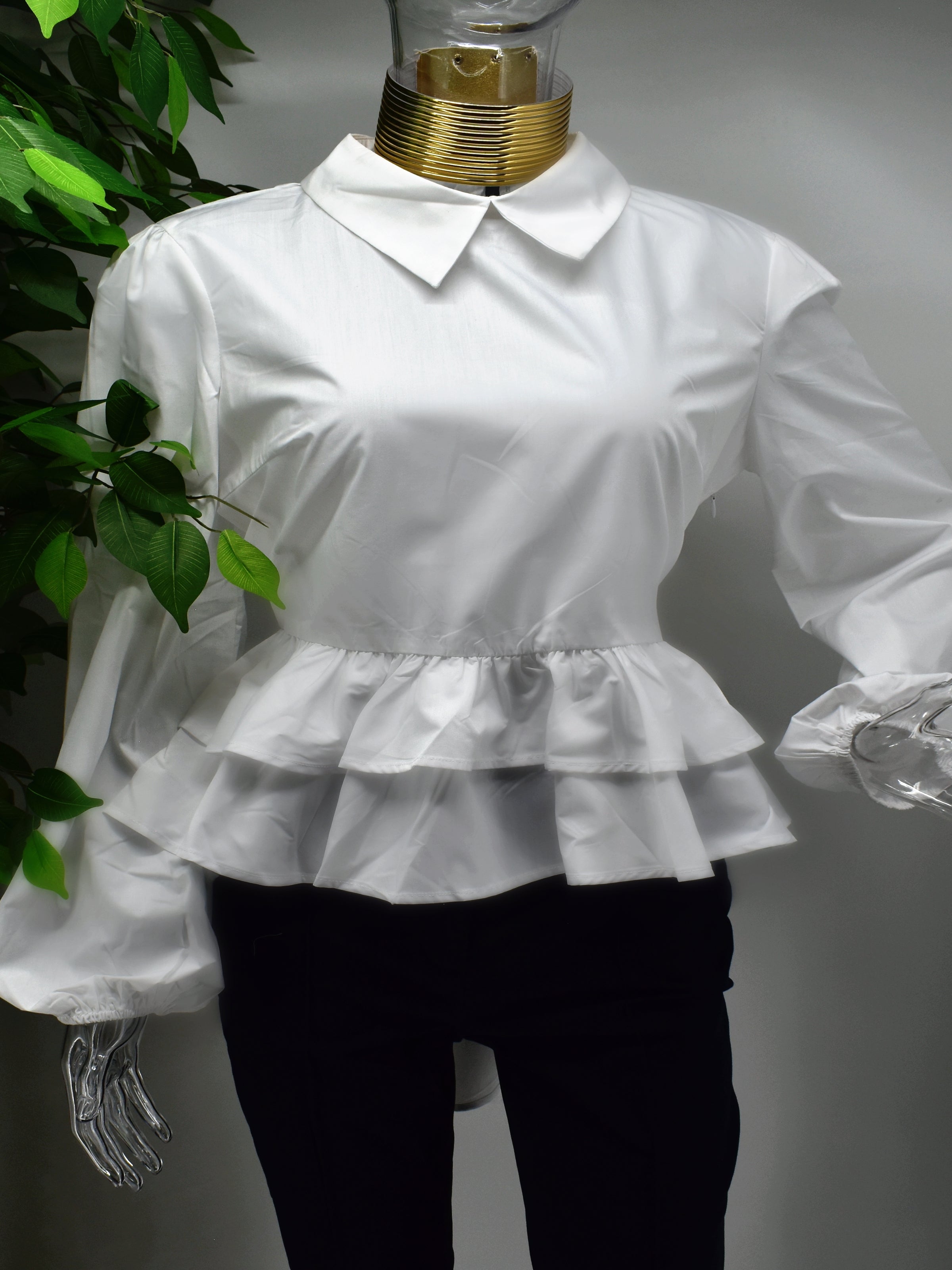 Fashion forward yet comfortably chic is what our Brier white shirt Blouse will deliver.  Brier is a white shirt blouse with a ruffled peplum waistline with the back hem longer than the front. 