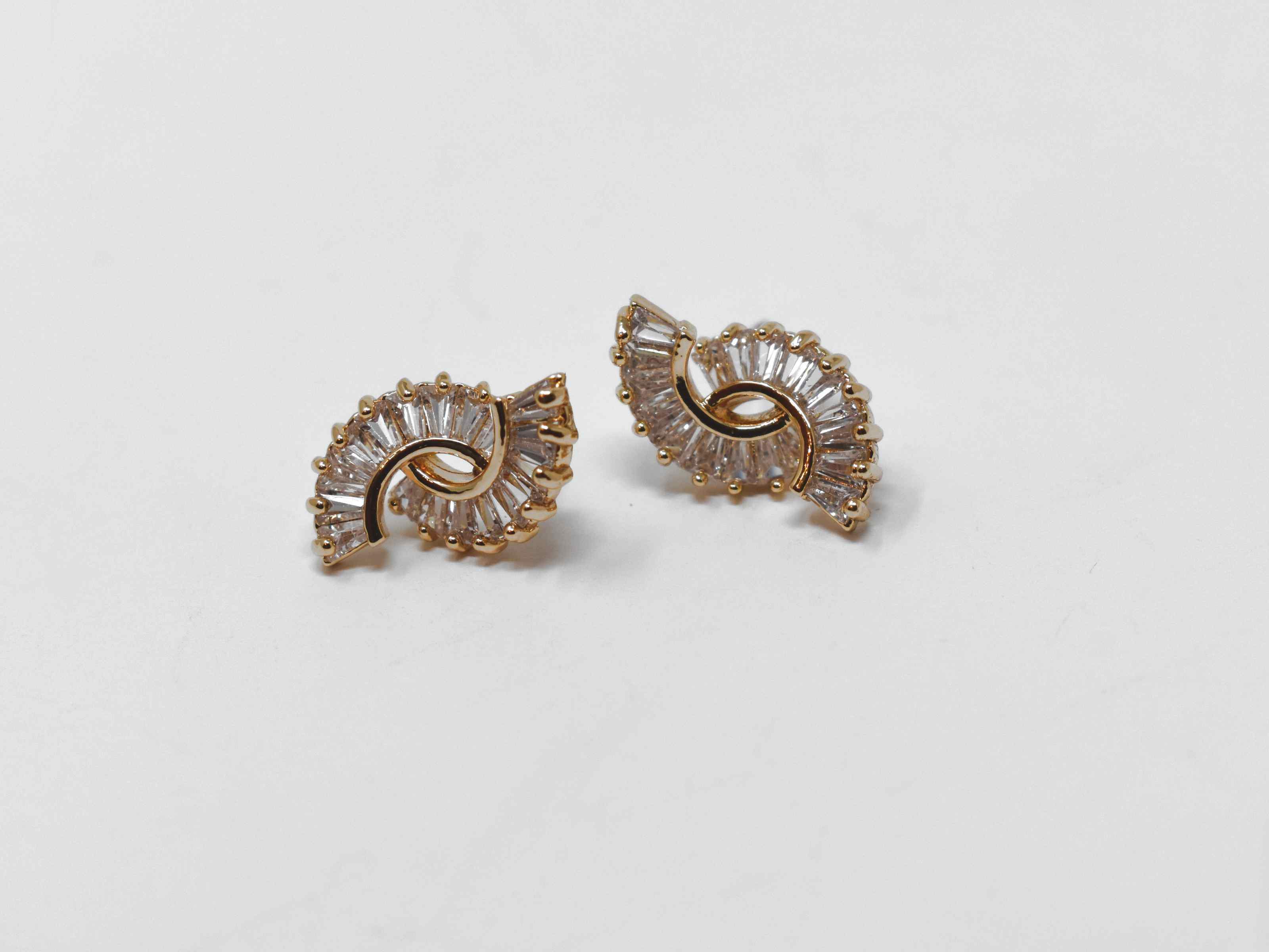 Beautifully crafted and cut to fit you can put your money on our Buddleja earrings. These gold circle cut earrings are  adorned with a cascade of clear stones. They are about a 1/2 inch in length with a push back clasp.