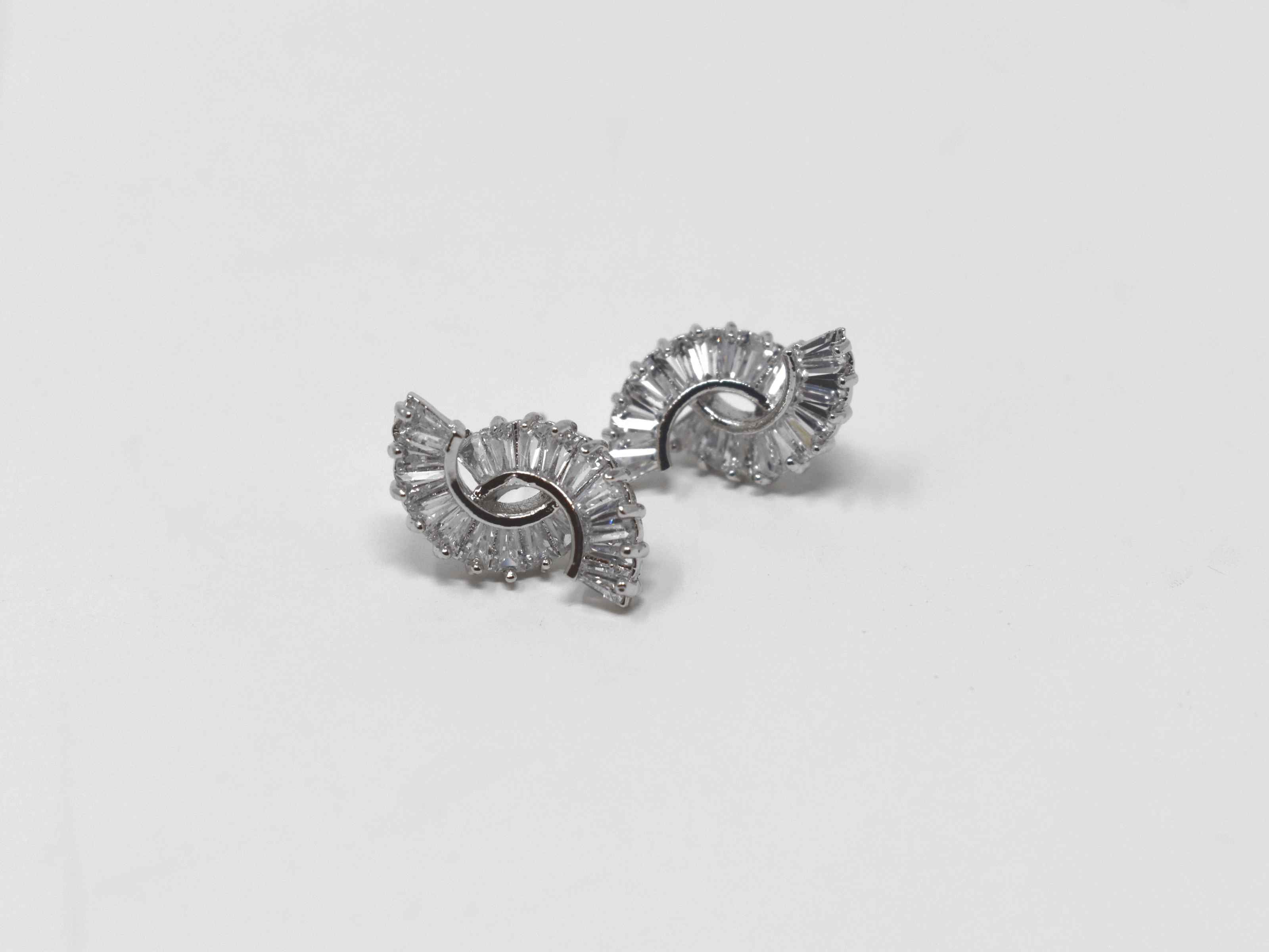 Beautifully crafted and cut to fit you can put your money on our Buddleja earrings. These silver circle cut earrings are  adorned with a cascade of clear stones. They are about a 1/2 inch in length with a push back clasp.