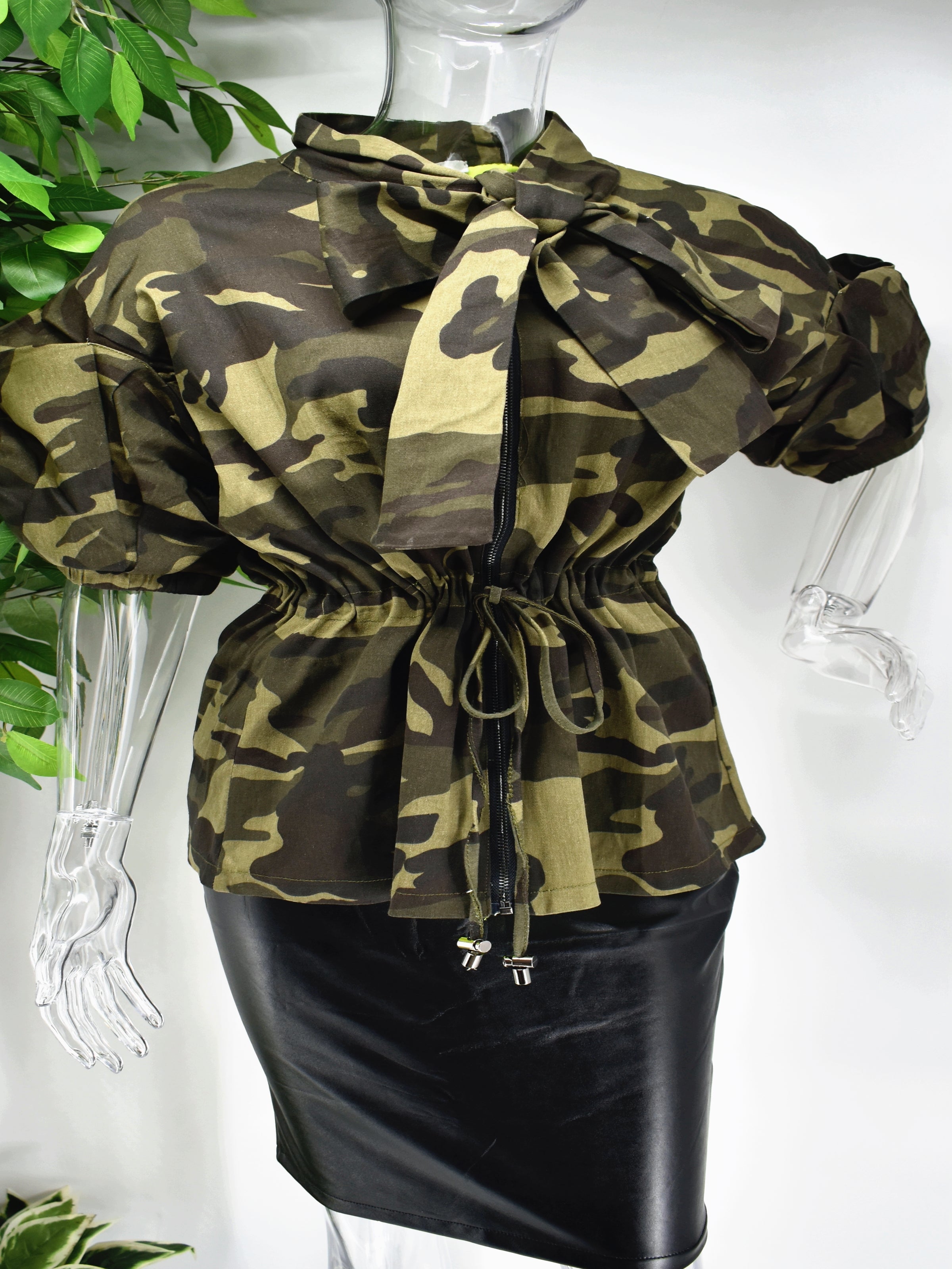 Different and irreplaceable is the words you would use to describe our Burma  camouflage top. Our Burma camo top is so unique. It has a cinched draw string waist and a unique puffed sleeve to add some drama to this classic color staple. 