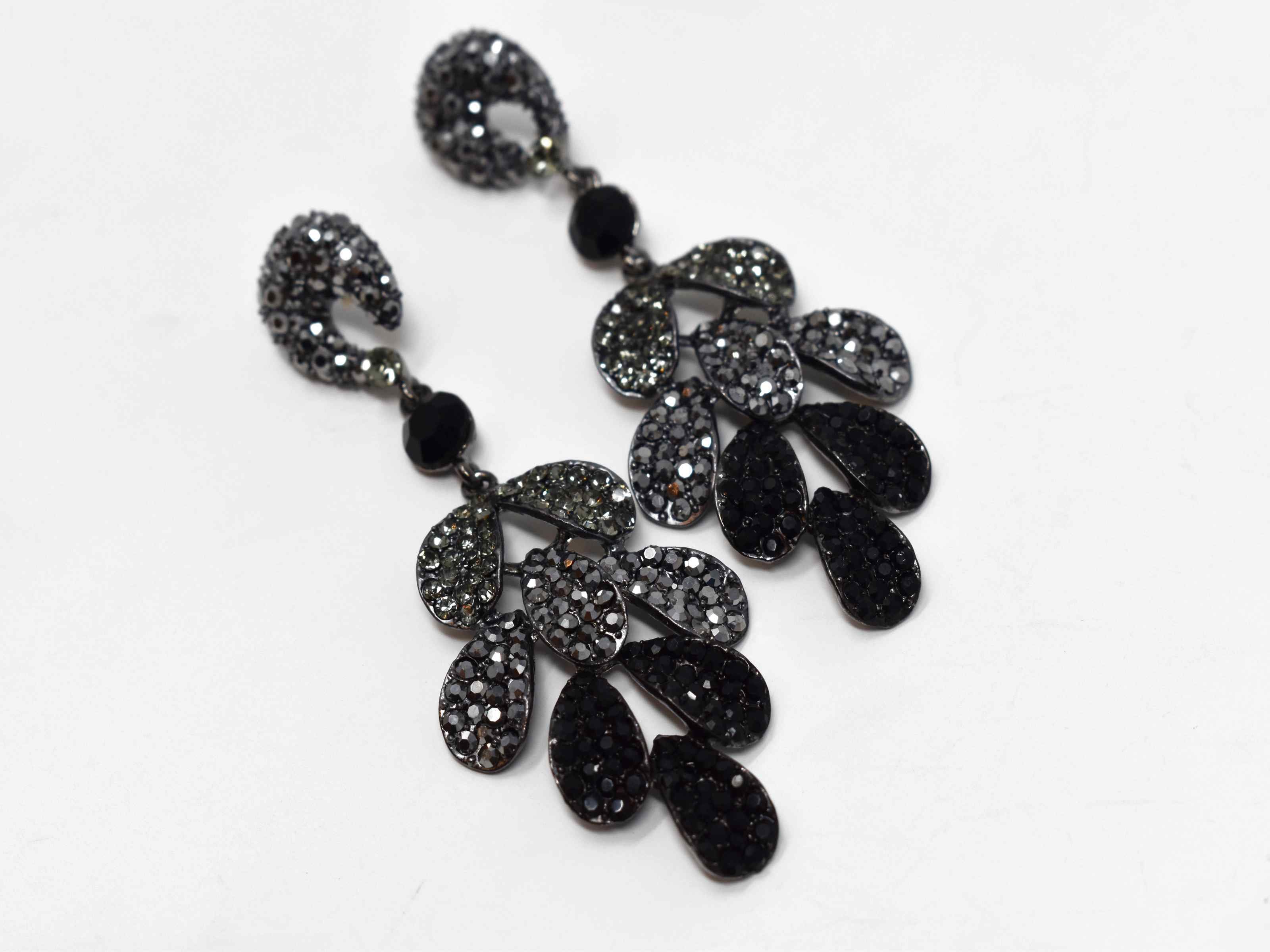 Our Erica Pewter dark silver earrings is designed to stand out from the crowd. These statement drop earrings are three tiered design accented with grey pewter and black stones. It is 3 1/2 inches in length with a push back clasp.