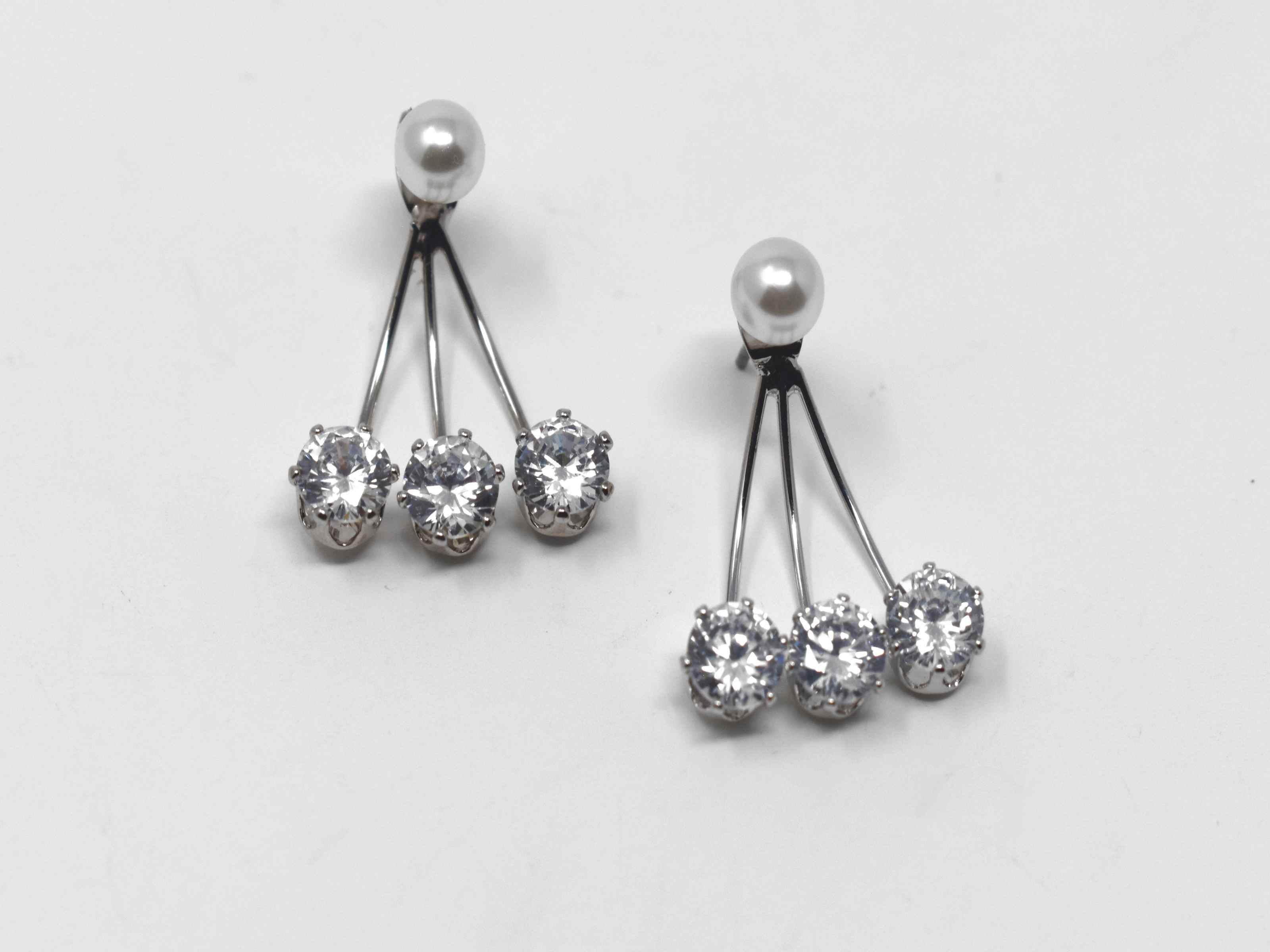 Make a statement with our on trend Erigeron earrings. These silver chandelier knobs have a pearl core with a cascade of stones. They are 1 inch in length with a push back clasp. 