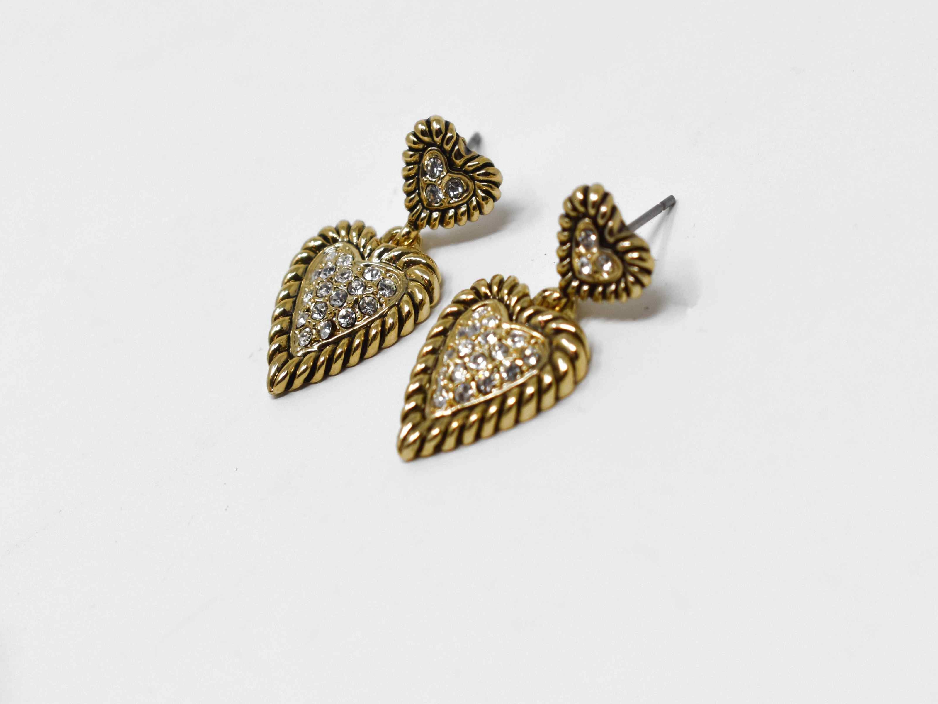 Forsythia is such a cute must have! These heart shaped designs are a gold tone adorned with stones. These earrings are 1 inch in length with a pushback clasp.