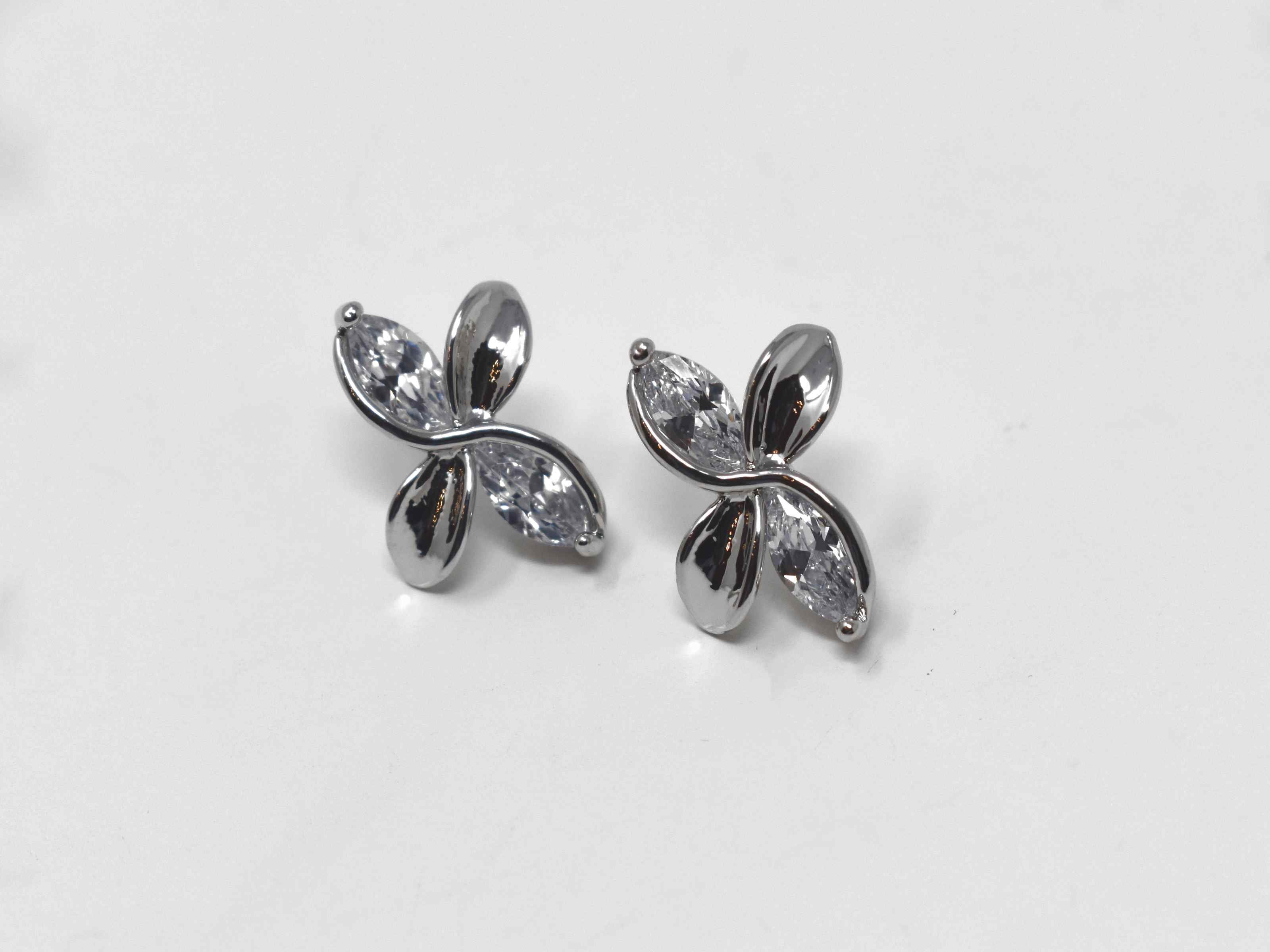 Our delicate and chic frangipani earrings are so versatile to help walk you through your style journey. They are a silver tone knob earrings with silver stones and a  push back clasp.