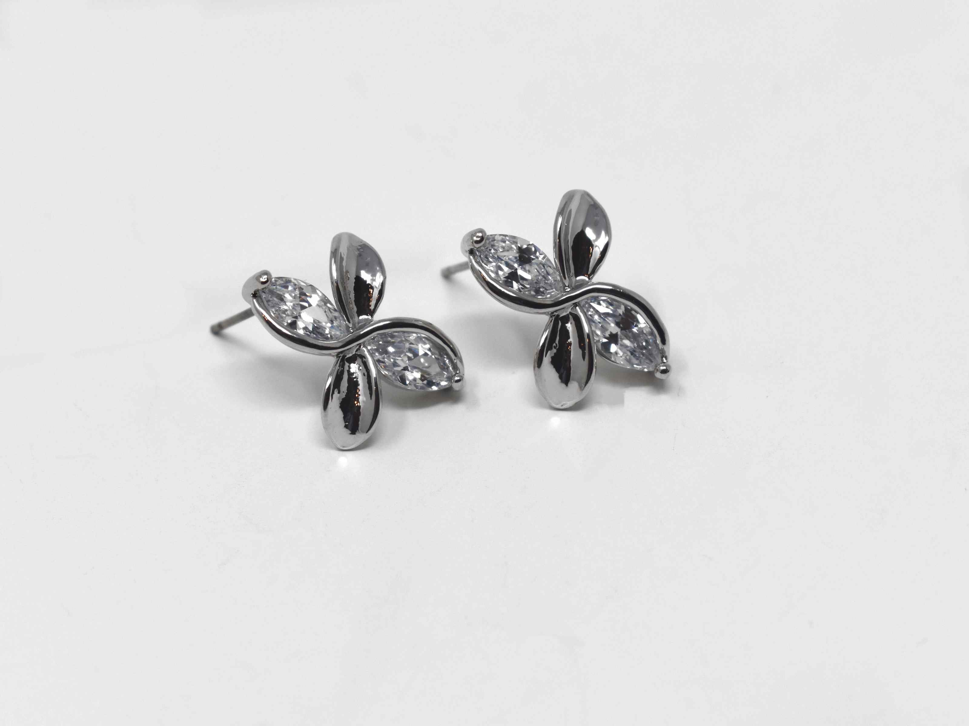 Our delicate and chic frangipani earrings are so versatile to help walk you through your style journey. They are a silver tone knob earrings with silver stones and a  push back clasp.