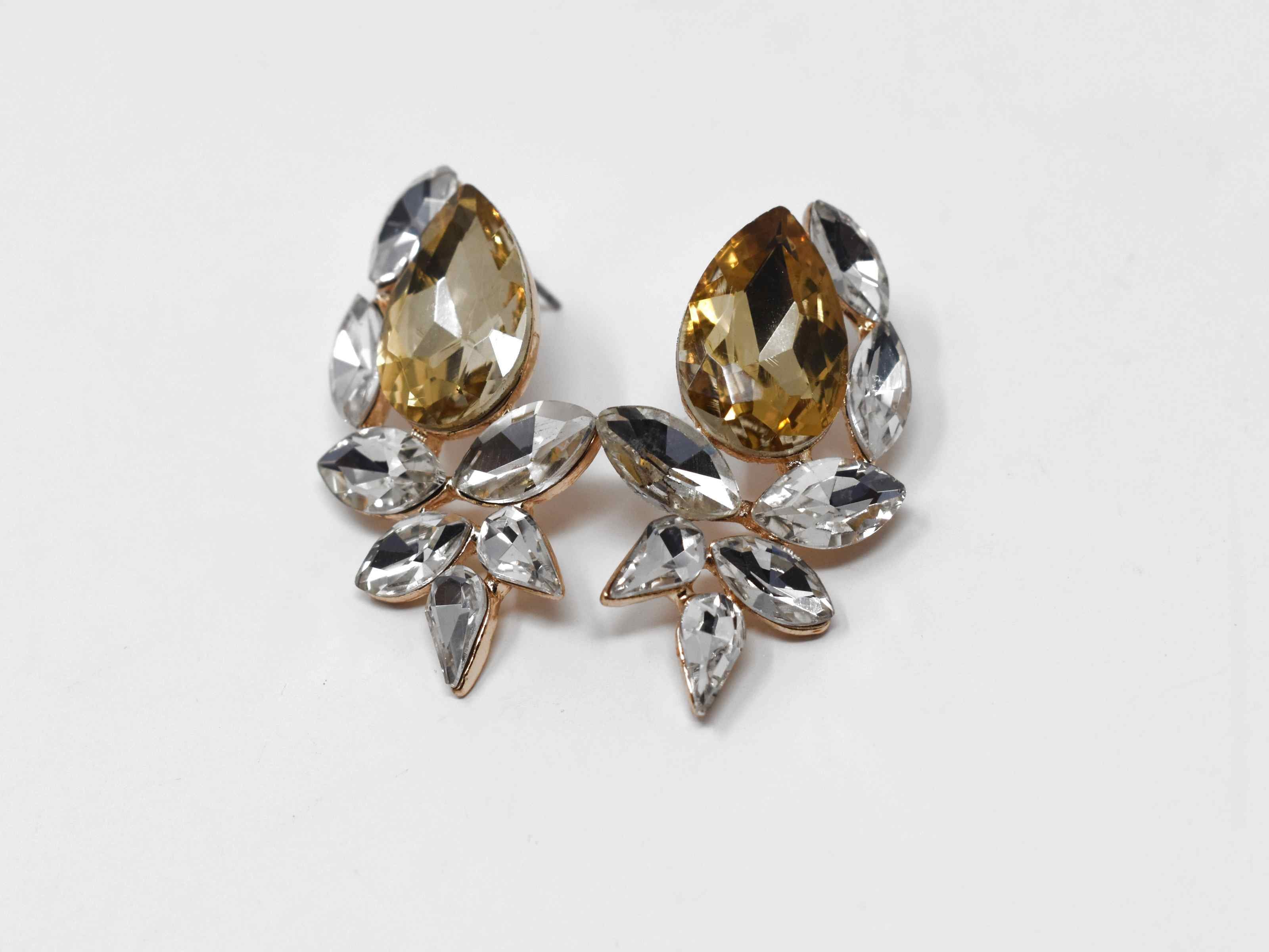 Time to Boss up with our Freesia Knob earrings. These earrings are a gold tone with gold and clear clusters of stones. They are 1 1/2 in length with a push back clasp.