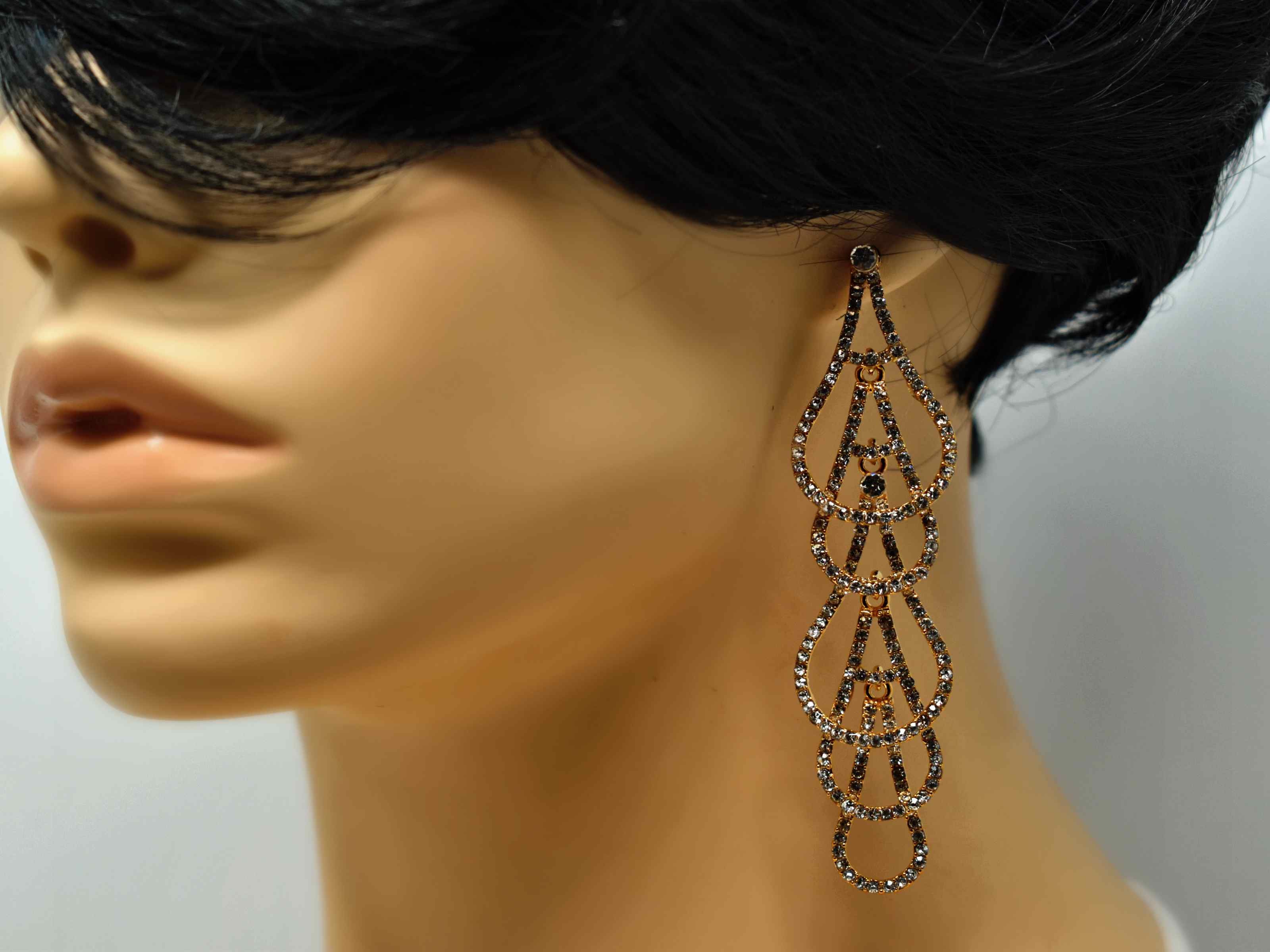 Elegantly crafted our goldenrod drop dangle earrings has a four tier A round design with clear stones. It is 3 1/2 inches in length with a push back clasp.