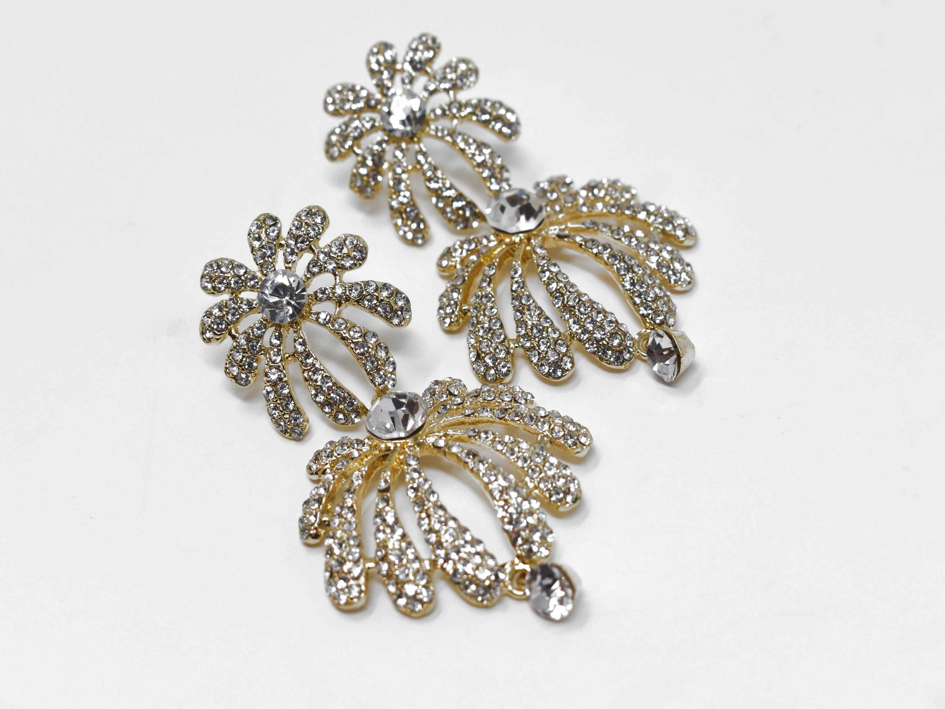 A radiant burst of sparkle is how you would describe our helenium gold earrings. These are a two tier floral burst formal drop earring with clear stones. They are 2 1/2 inches in length with a pushback clasp.