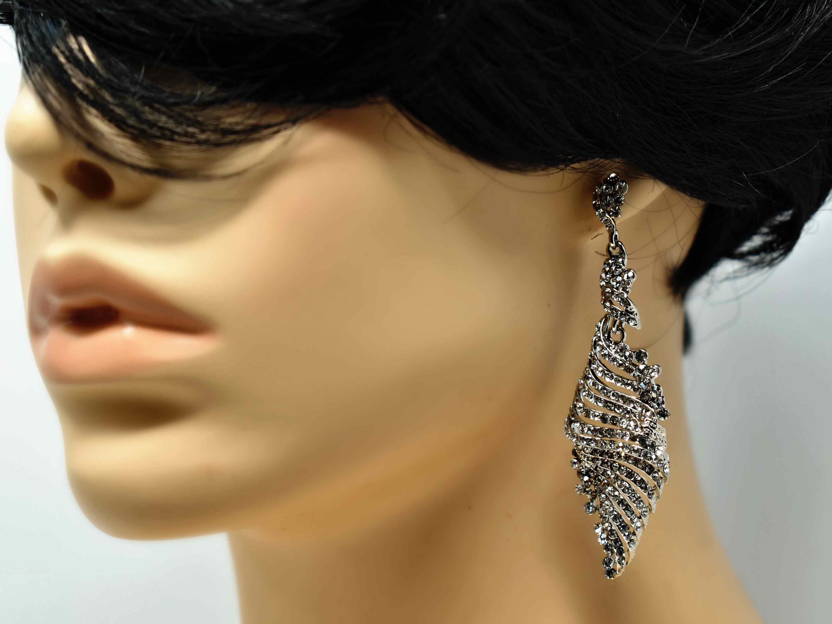 Our glitzy heliotrope silver dangle leaf style earrings are encrusted with clear stones  all over.  It is  3 inches in length with a push back clasp.