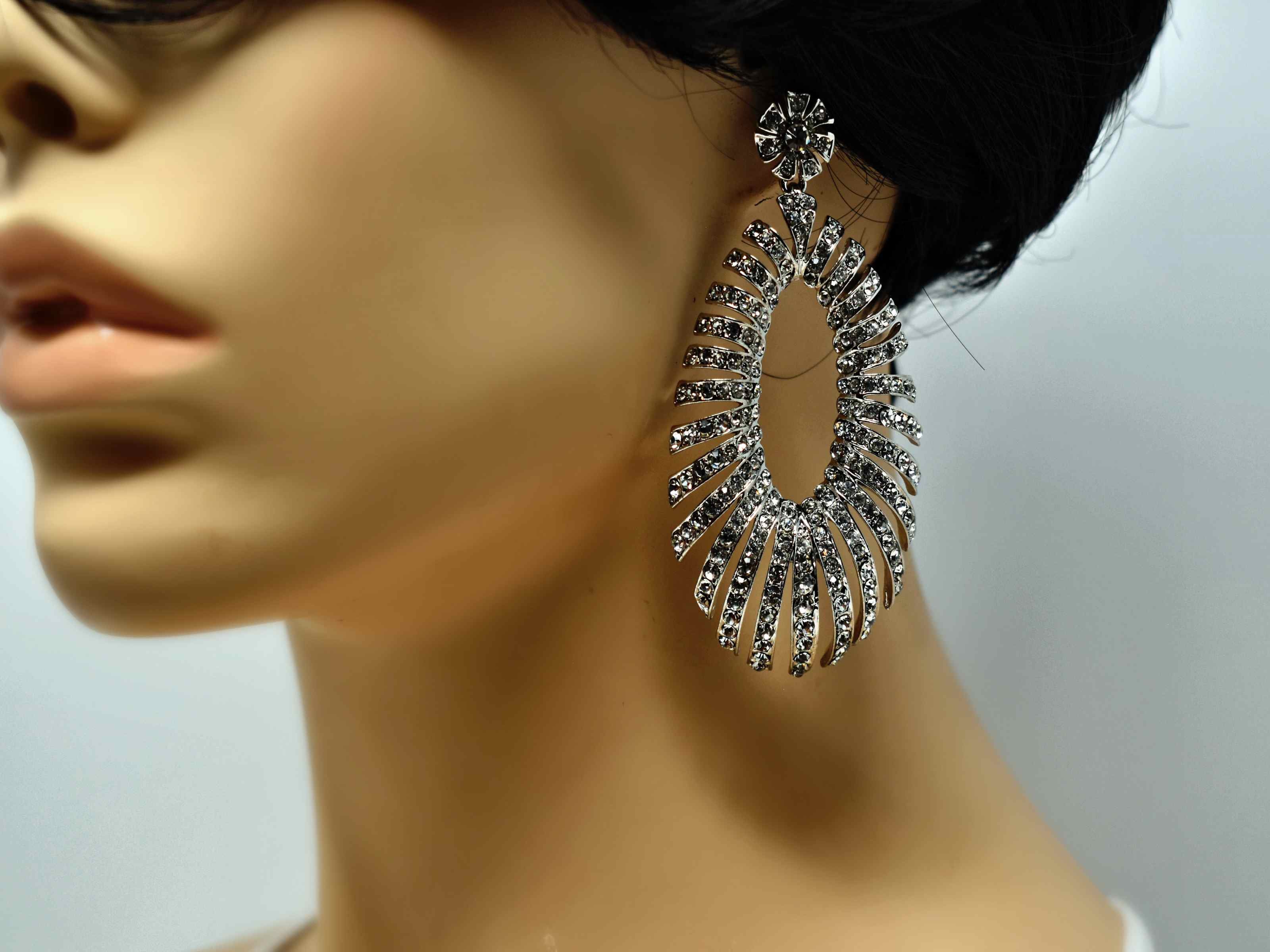 A timeless treasure! These Jamesia silver formal statement earrings have a unique oval shape. These drop earrings are 3 inches in length with a push back clasp.