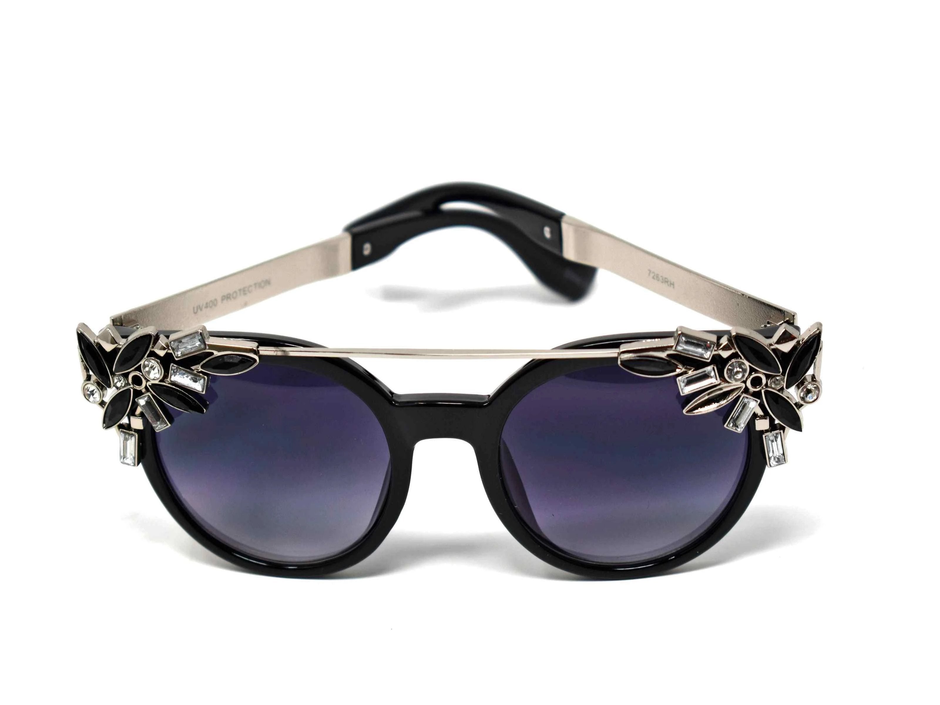 Trend setter and attention getter is what they will call you in these Pansy black sunglasses with a sleek silver trim adorned in black and clear gems, in a pantos style frame.