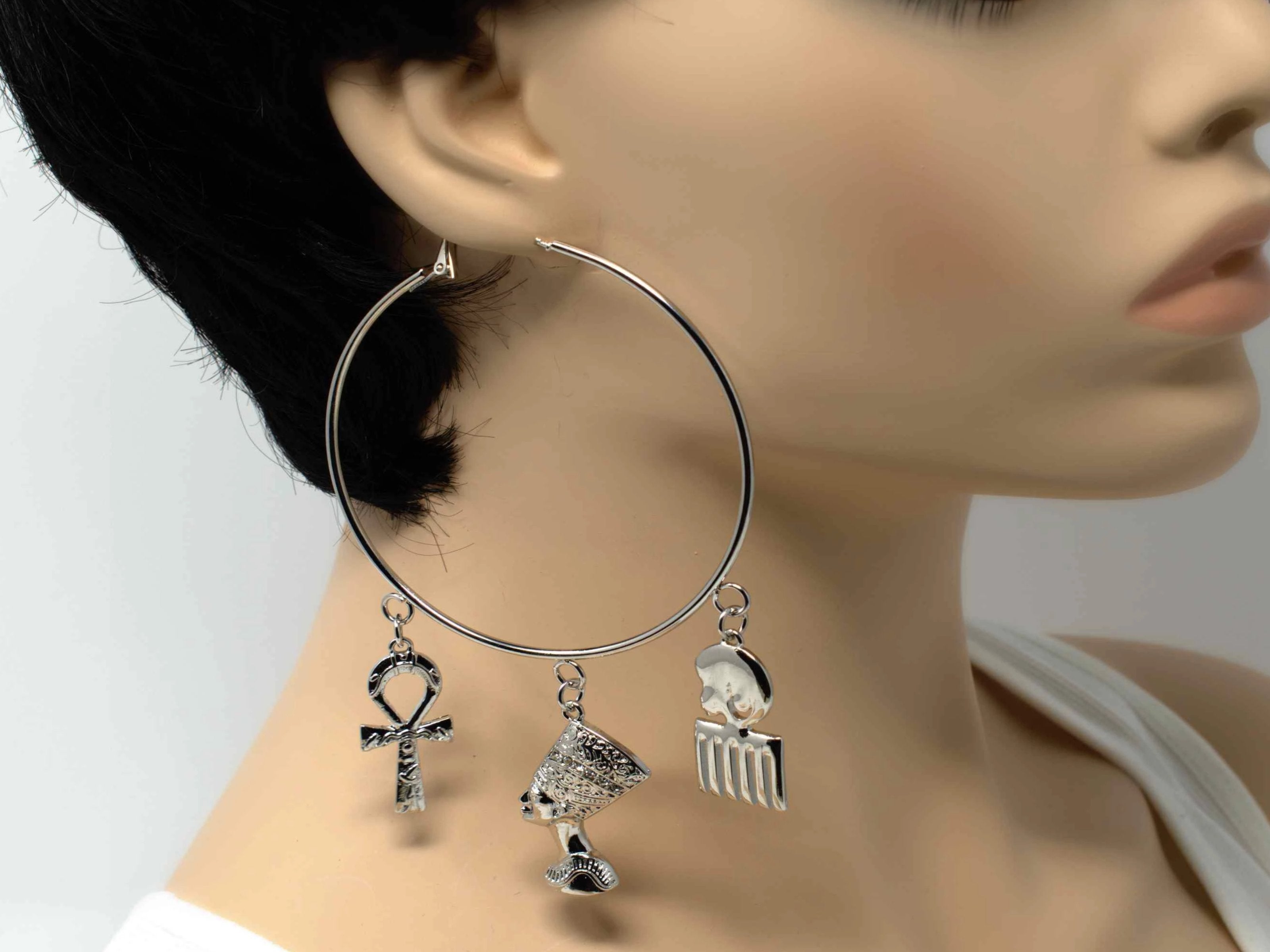 A radiant stylish afro chic silver hoop fashion earring with afro centric charms.
