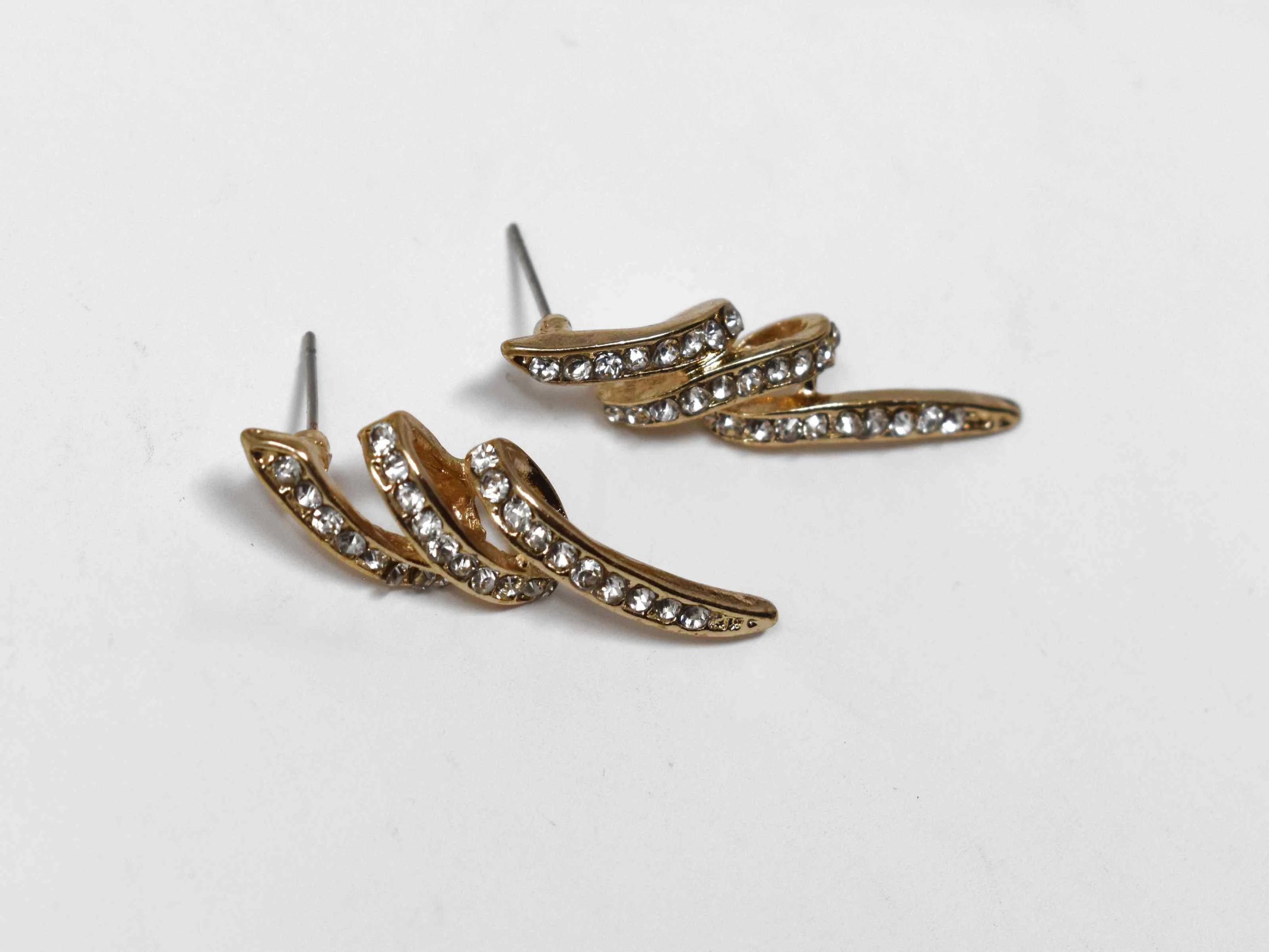 The only conclusion you will come to is that our Spark gold earrings are a timeless treasure. Its lighting coil design with stone accents are about 1 1/2" in length and has a pushback design.