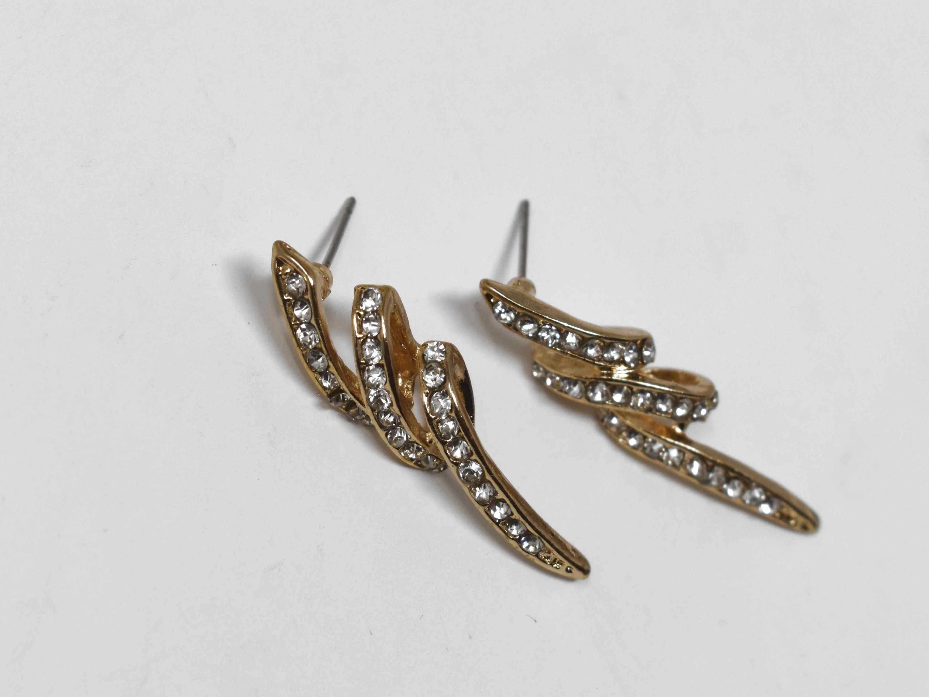 The only conclusion you will come to is that our Spark gold earrings are a timeless treasure. Its lighting coil design with stone accents are about 1 1/2" in length and has a pushback design.
