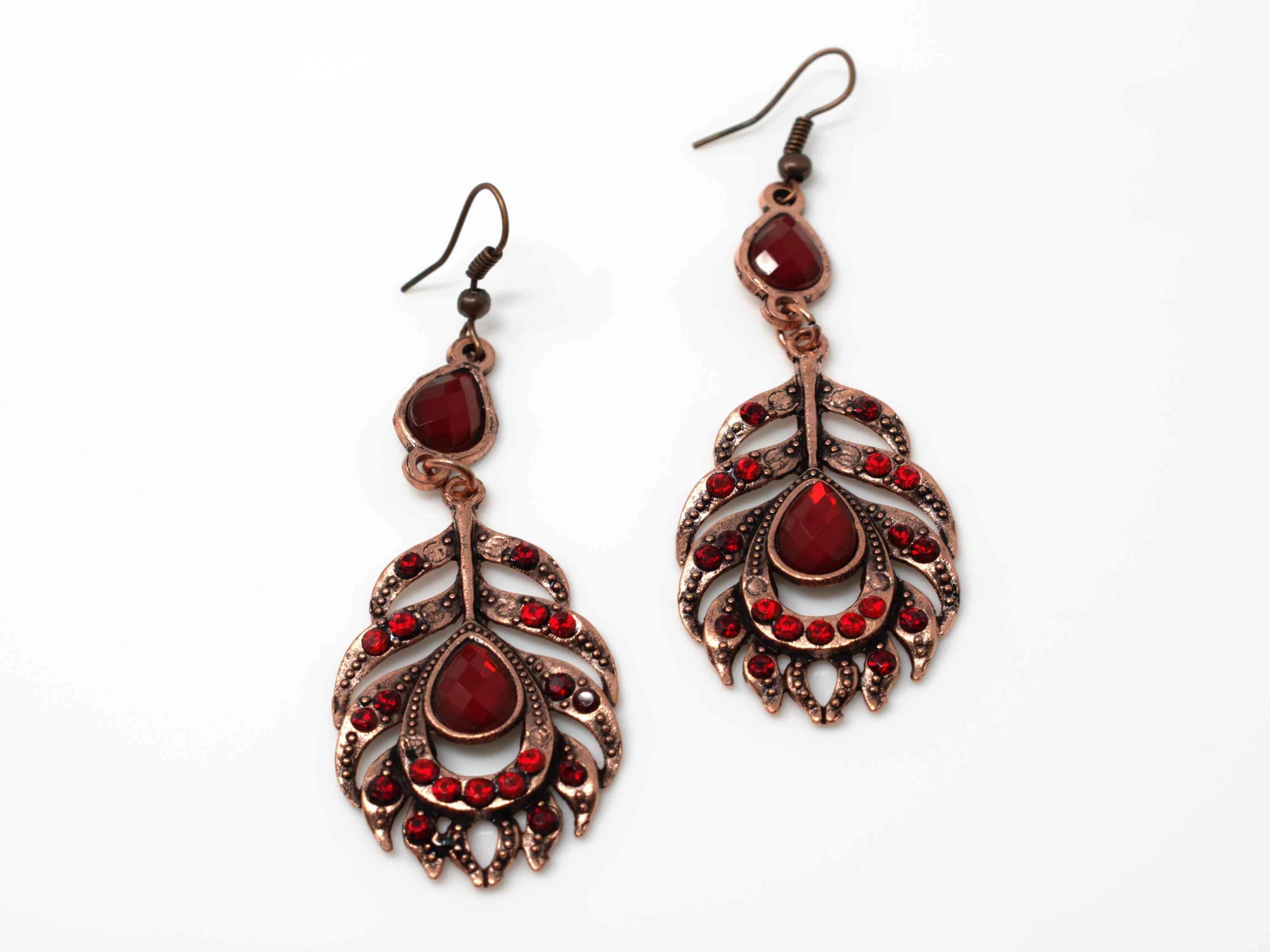 A dainty rose drop dangle feather fashion earring with red accent stones and a fish hook clasp.